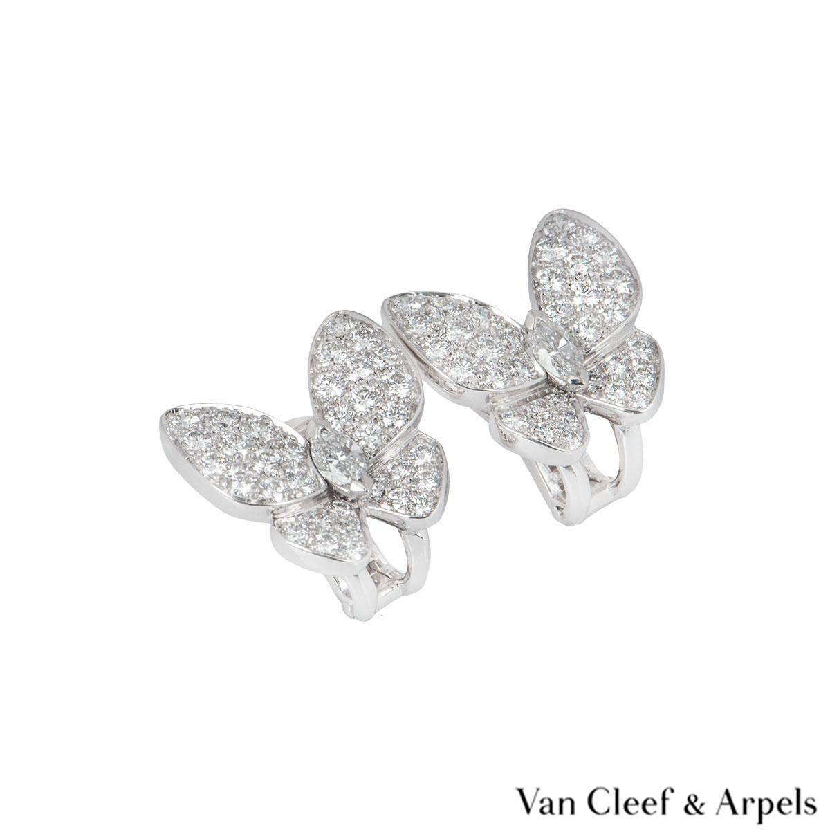 A pair of 18k white gold and diamond butterfly earrings by Van cleef & Arpels from the Fauna collection. The earrings feature a butterfly design pave set with round brilliant cut diamonds on the wings and a marquise cut diamond in the centre. There