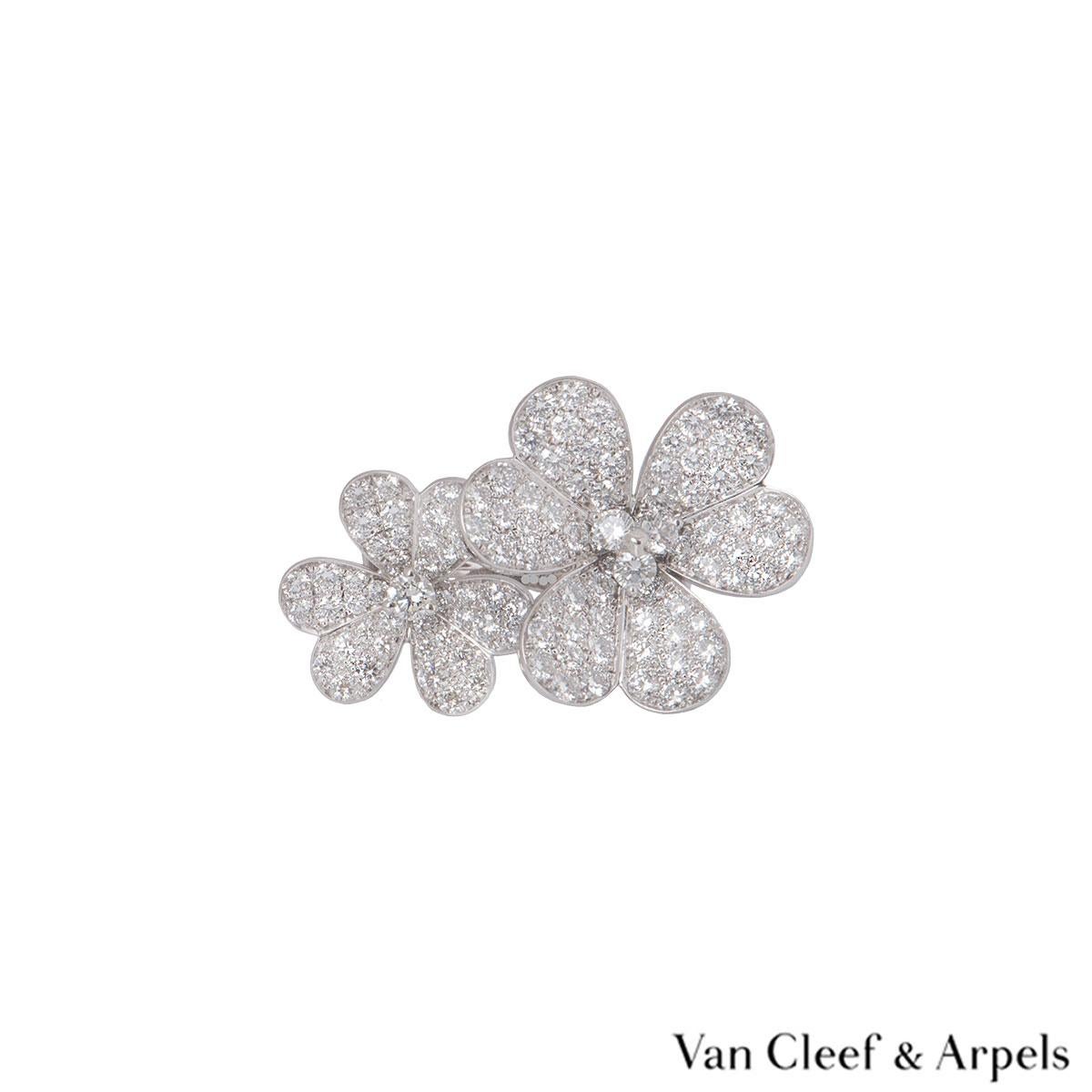 An 18k white gold and diamond ring by Van Cleef & Arpels from the Flora collection. The ring comprises of 2 flowers set with round brilliant cut diamonds in a pave setting on the petals and round brilliant cut diamonds in the centre. The ring has