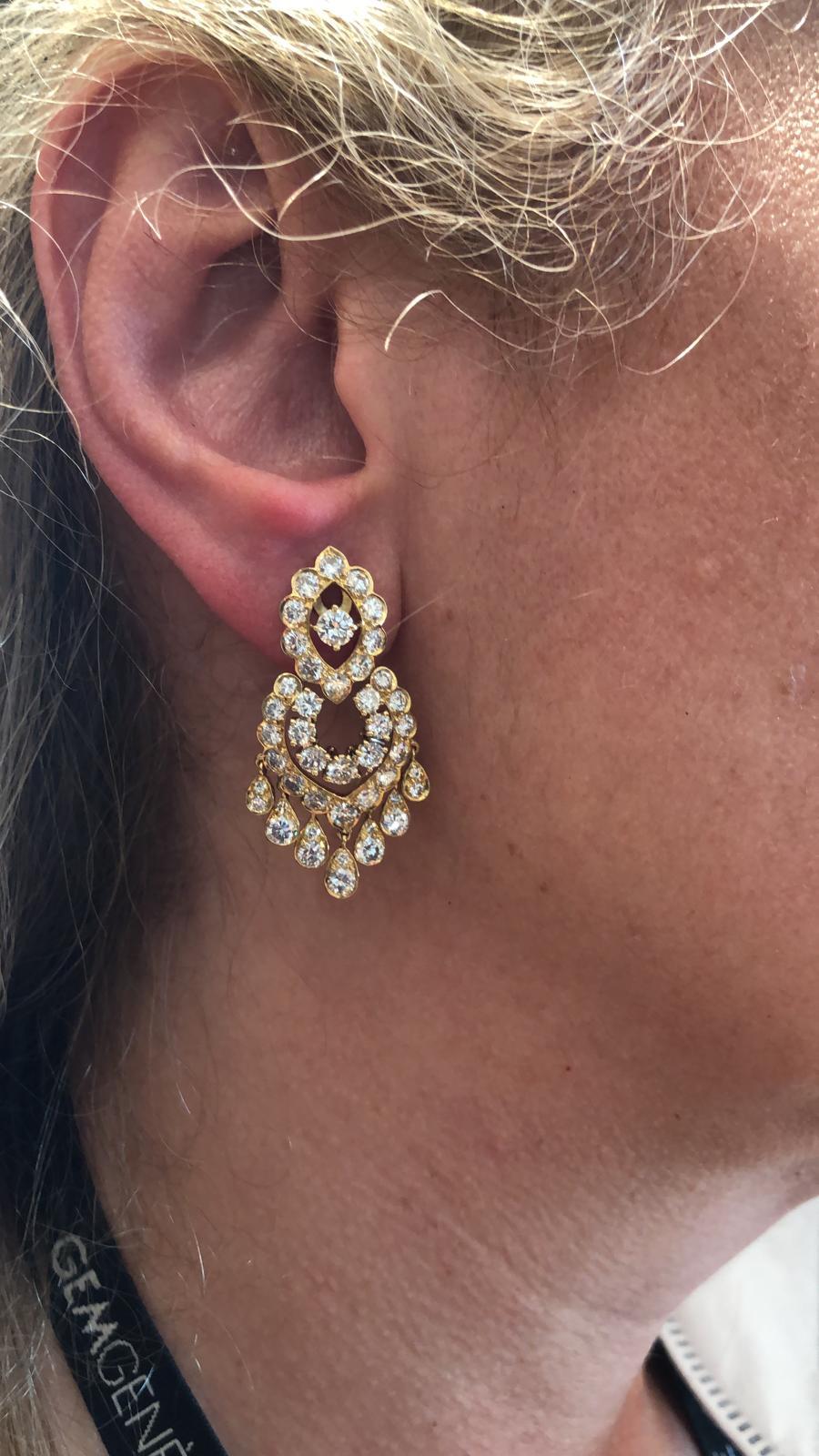 Van Cleef & Arpels Diamond Fringe Chandelier Earrings in 18k Yellow Gold.

A pair of articulated earrings by Van Cleef & Arpels, with a marquise-shaped floret surrounded by a chandelier of scalloped frames and fringed passementerie. The movement of