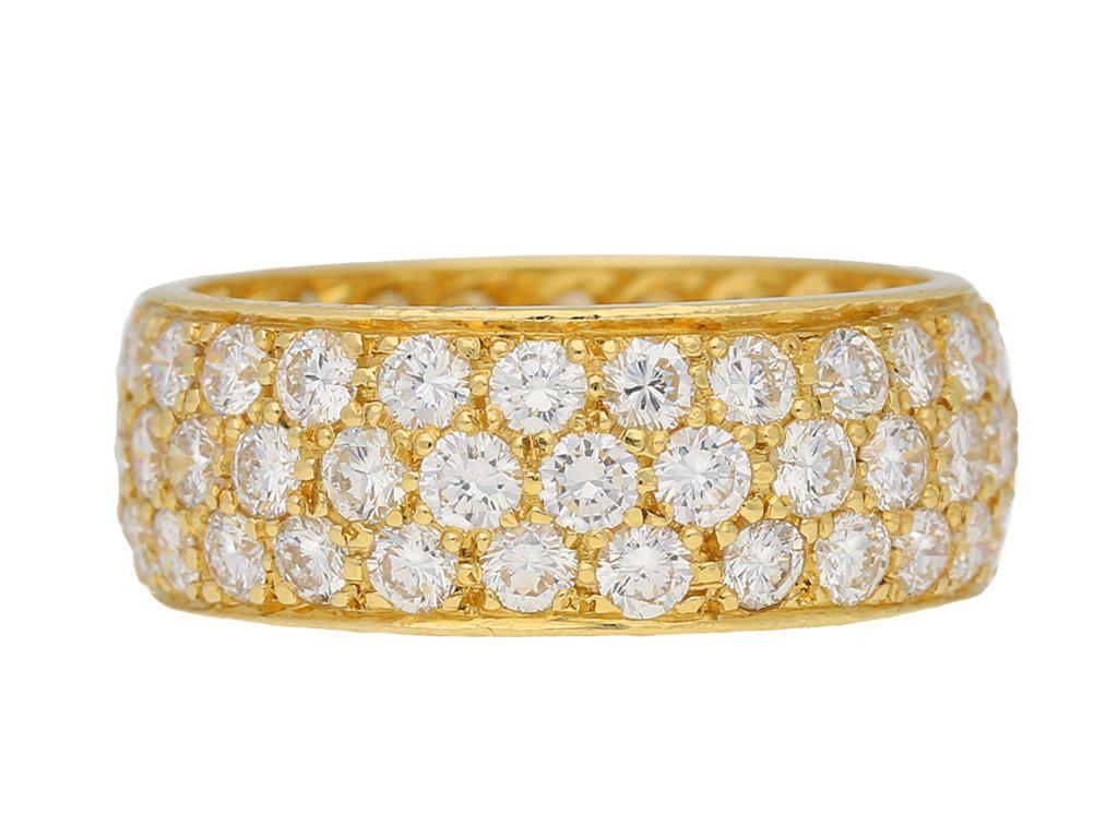 Van Cleef & Arpels vintage diamond ring. Set with three rows of round brilliant cut diamonds, seventy five in total, in open back grain settings with a combined approximate weight of 3.00 carats, to a smoothly conforming full band with fine rubover