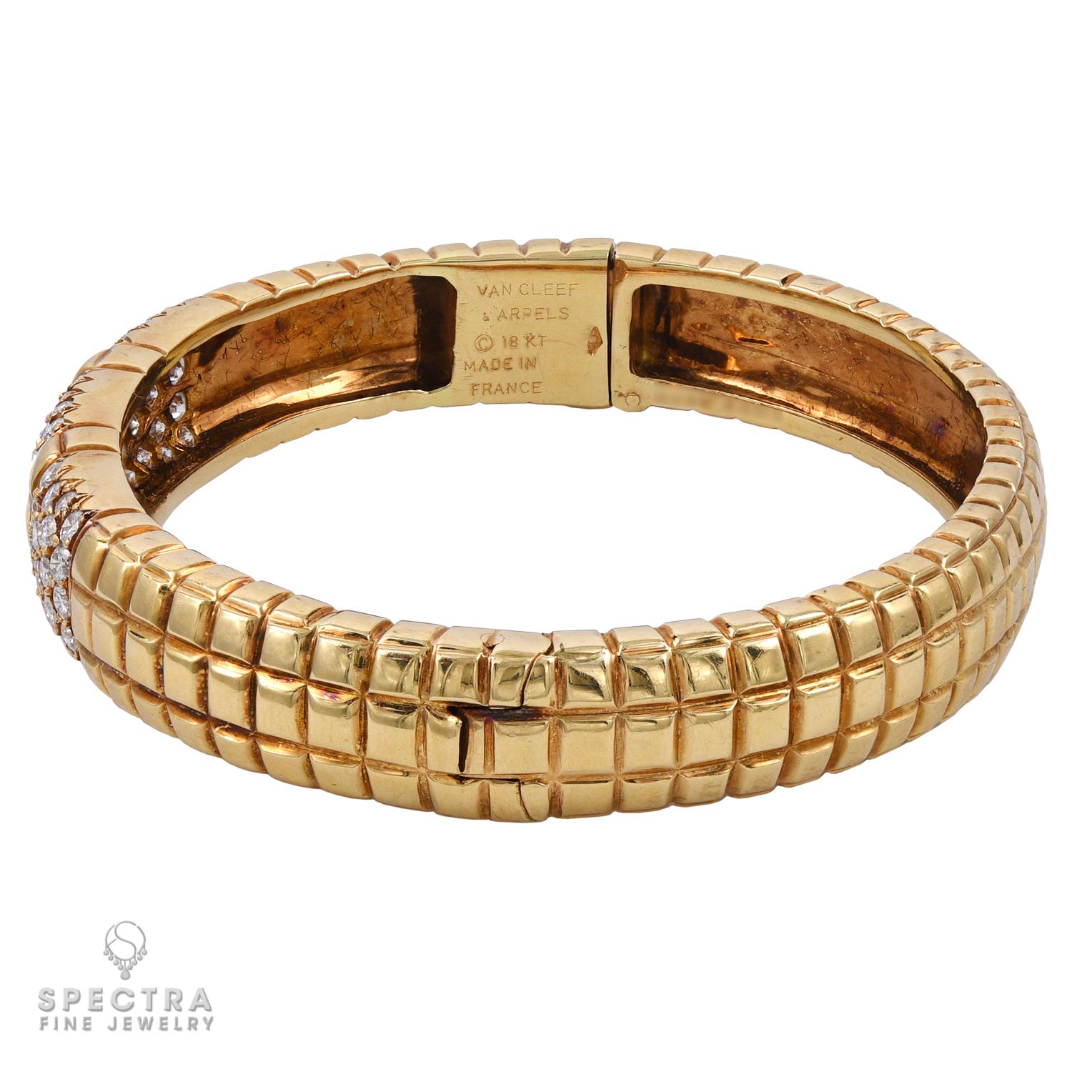 Textured gold and diamonds are arranged into two distinct geometric patterns adorning the full graceful arc of this Van Cleef & Arpels Vintage Gold Diamond Bangle Bracelet, made in France in the 20th century, circa 1970s. The bracelet is crafted in