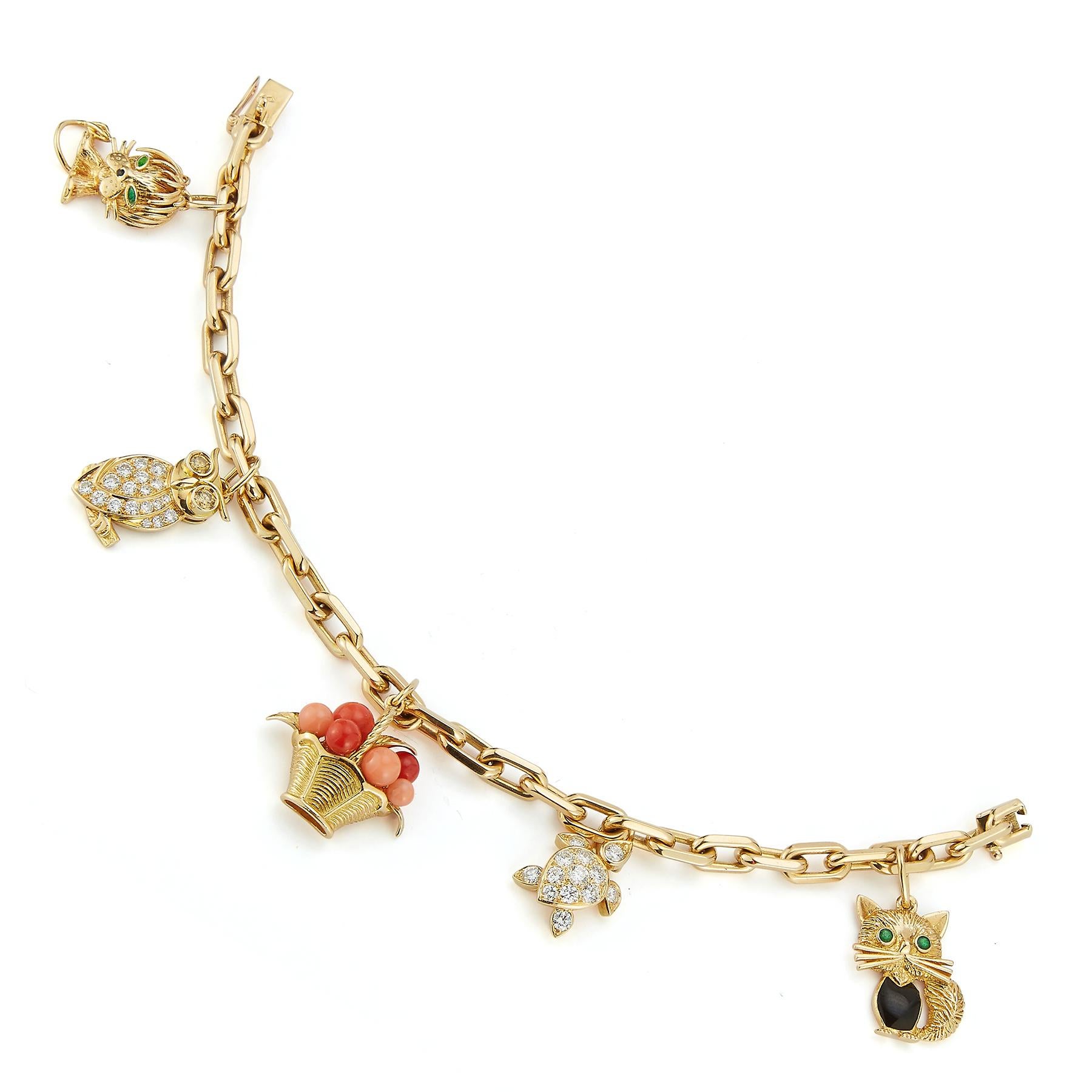 Van Cleef & Arpels Diamond & Gold Charm Bracelet

5 charms consisting of a kitten, turtle basket of oranges, owl  & a lion.

Set with diamonds, coral, emerald & onyx set in 18k yellow gold.

The two diamonds charms are not signed

Measurements: 7.5