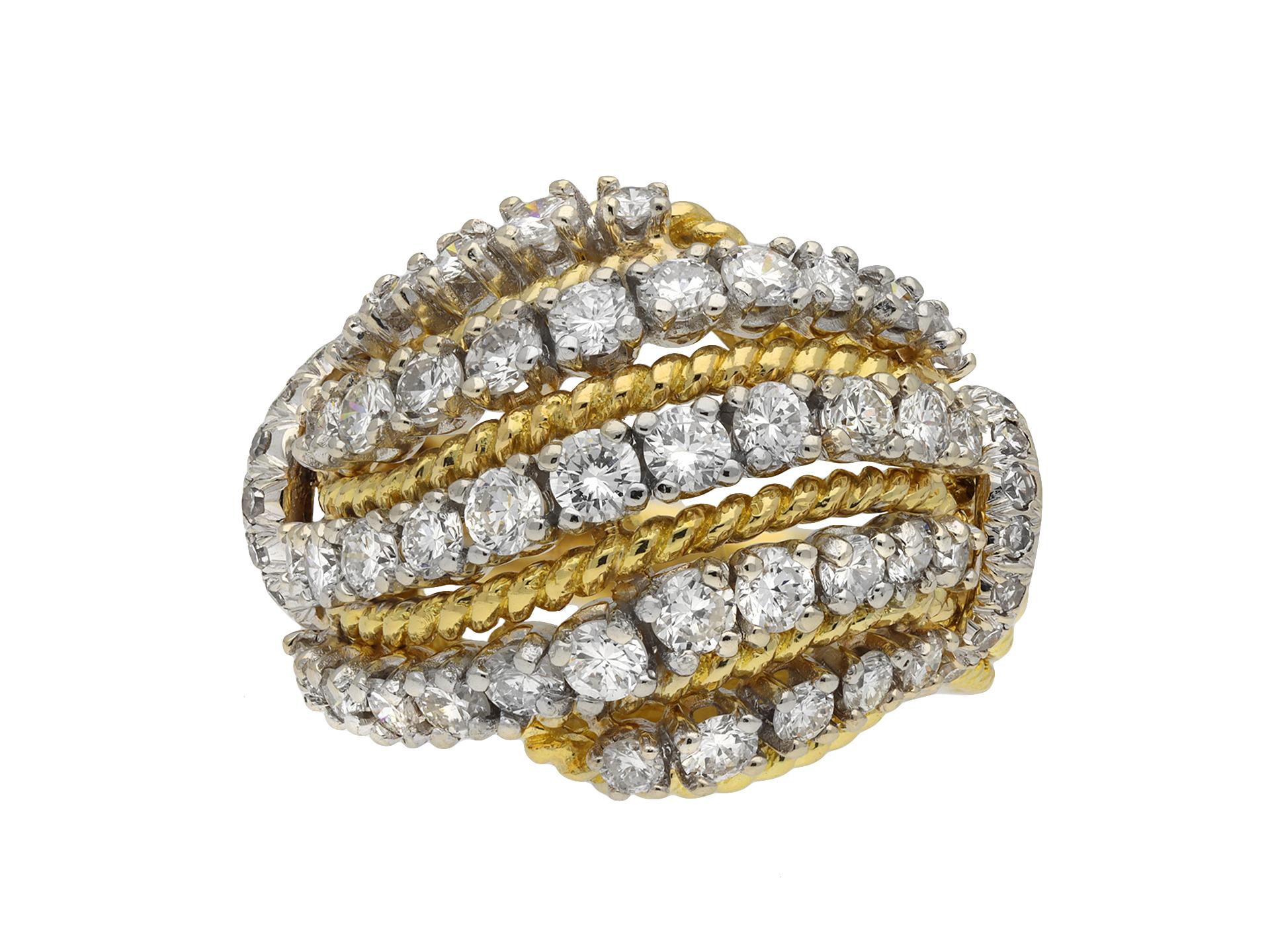 Diamond cocktail ring, by Van Cleef & Arpels circa 1960. A yellow and white gold ring with heavy openwork bombé bezel diagonally set with five single rows of forty three round brilliant cut diamonds in white gold settings with an approximate total