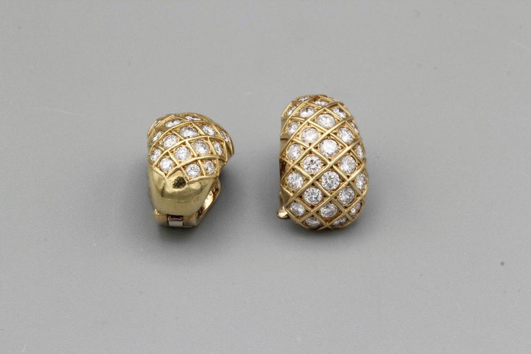 Fine pair of diamond and 18K yellow gold earrings by Van Cleef & Arpels, circa 1980s. They feature very high grade round brilliant cut diamonds, approx. 5.0 carats total weight. 

Hallmarks: VCA, reference numbers, French 18K gold assay mark,