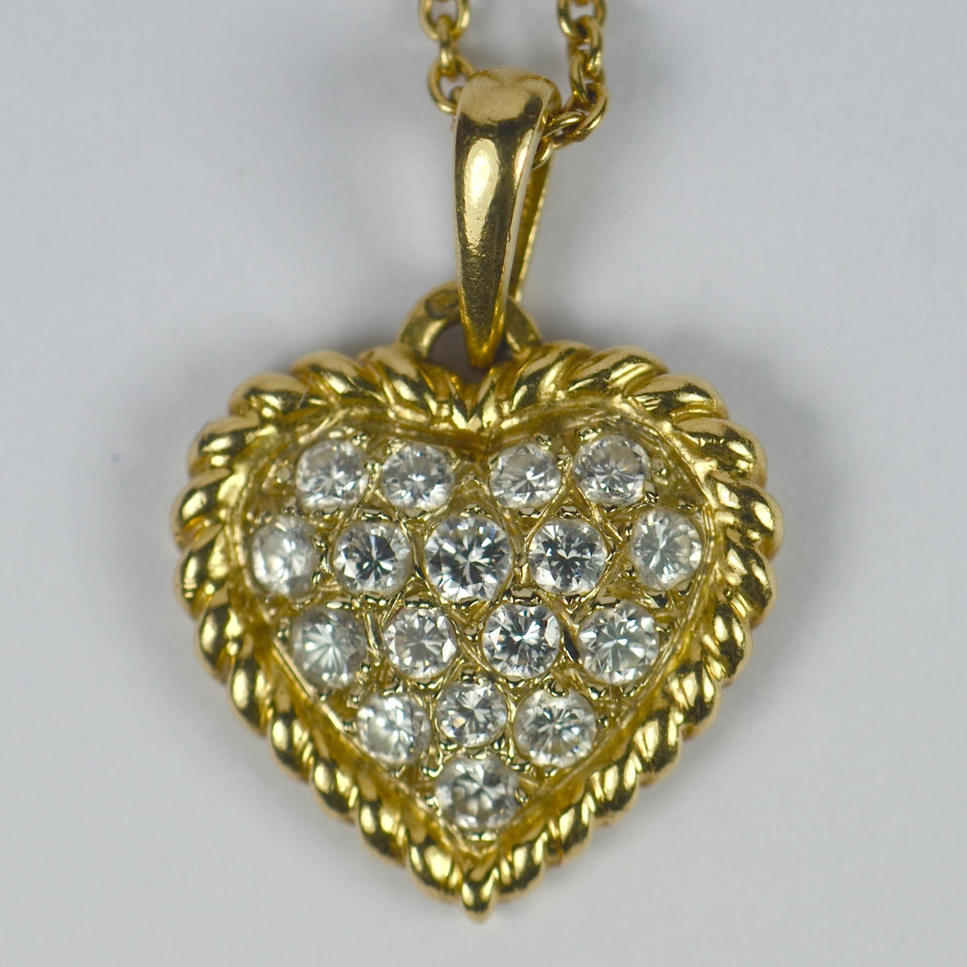 A classic pave diamond set heart pendant on a fine 18kt yellow gold chain necklace by Van Cleef & Arpels. The heart is set with 17 brilliant round cut diamonds (VVS clarity, E-F colour) enclosed by a rope-twist gold border, with a total diamond