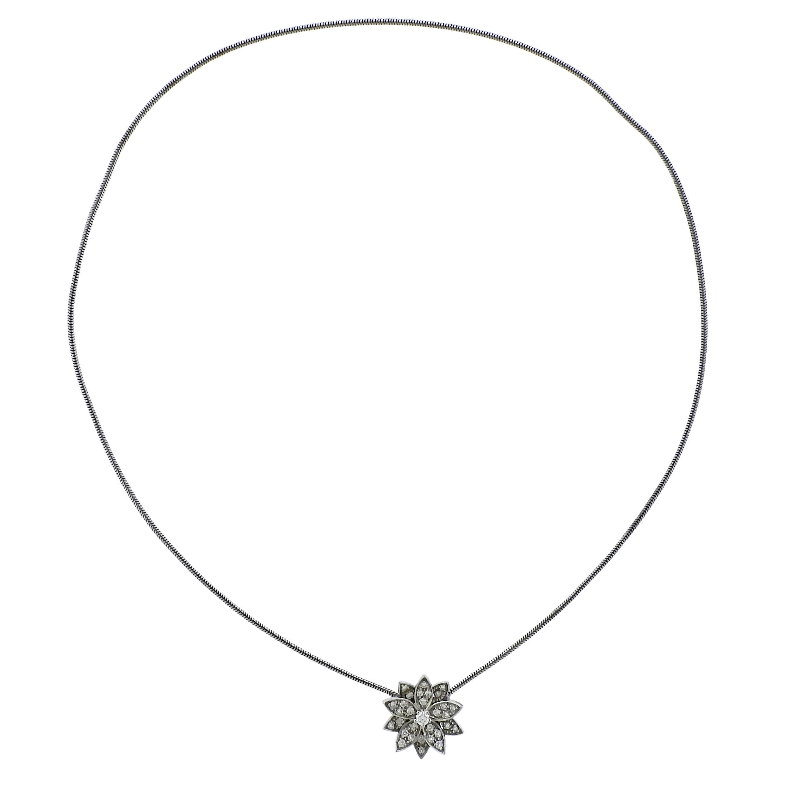 18k white gold Lotus pendant necklace, crafted by Van Cleef & Arpels, decorate with approx. 0.46ctw ni FG/VVS diamonds. Retail $10300., comes with pouch.  Necklace is 15 3/4