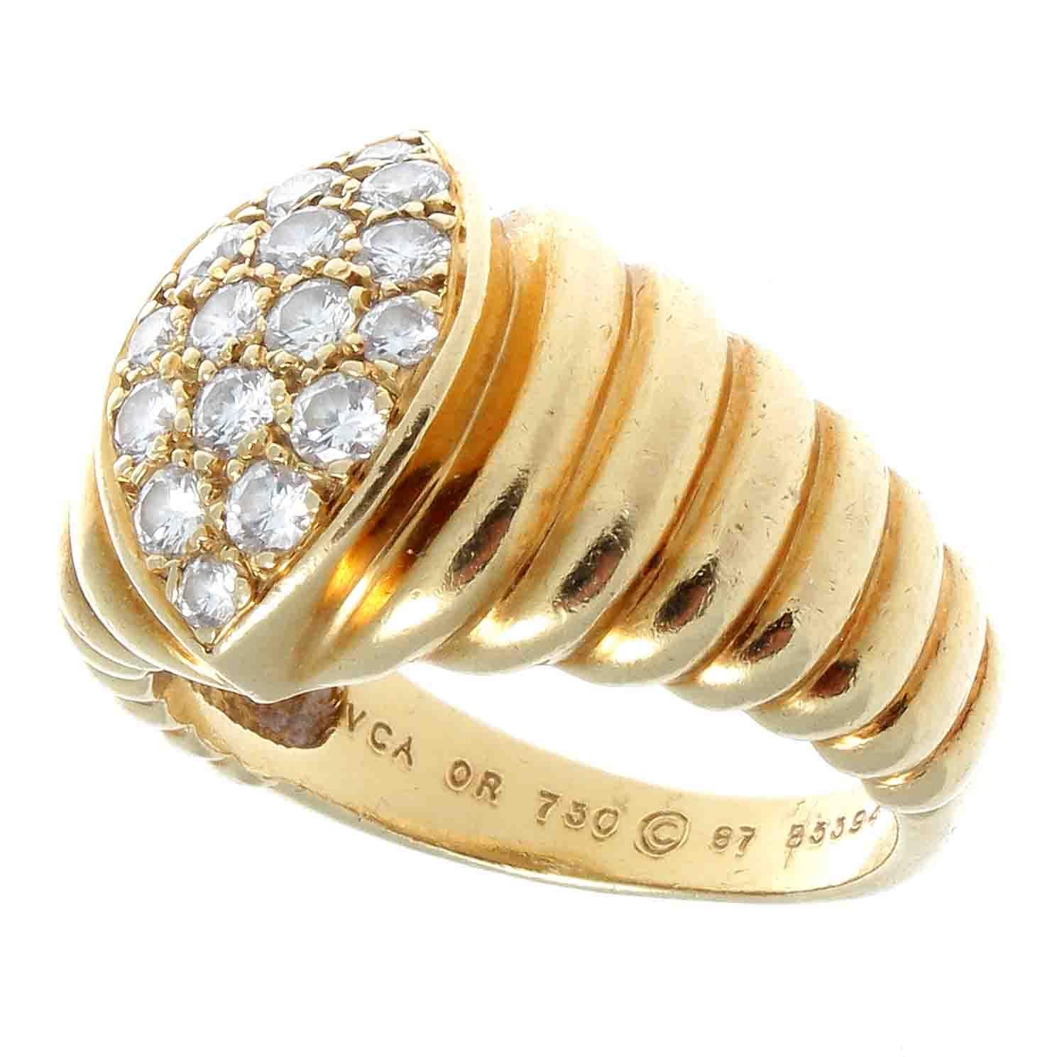 A symmetrical and eye pleasing design classically made fashionable by the creators at VCA. Featuring 16 white clean well matched diamonds set in hand crafted 18 yellow gold. Signed VCA, numbered and stamped with French hallmarks. Ring size 6 and may