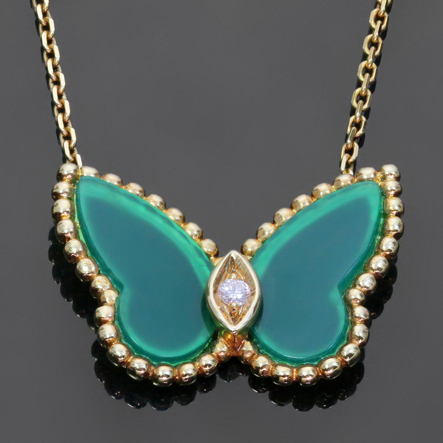 This iconic Van Cleef & Arpels necklace is crafted in 18k yellow gold and features a butterfly shaped pendant suspended from a link chain and accented with green chalcedony wings and a brilliant-cut round diamond of an estimated 0.03 carats. Made in