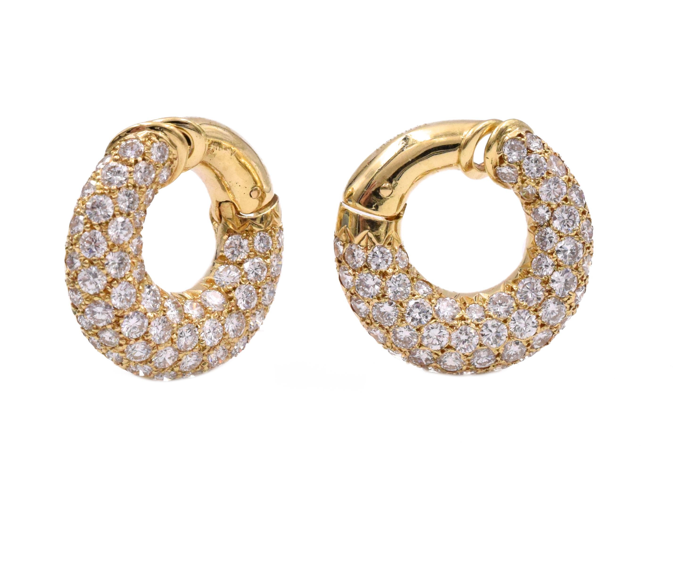 Pair of Gold and Diamond Hoop Earclips, Van Cleef & Arpels, France. The bombé hoops pavé- set with 116 round diamonds approximately 7.00 cts, color F-G, clarity VS. 
Signed VCA, 79, no. xxxxxx CS, 
with maker's marks and French assay marks. 