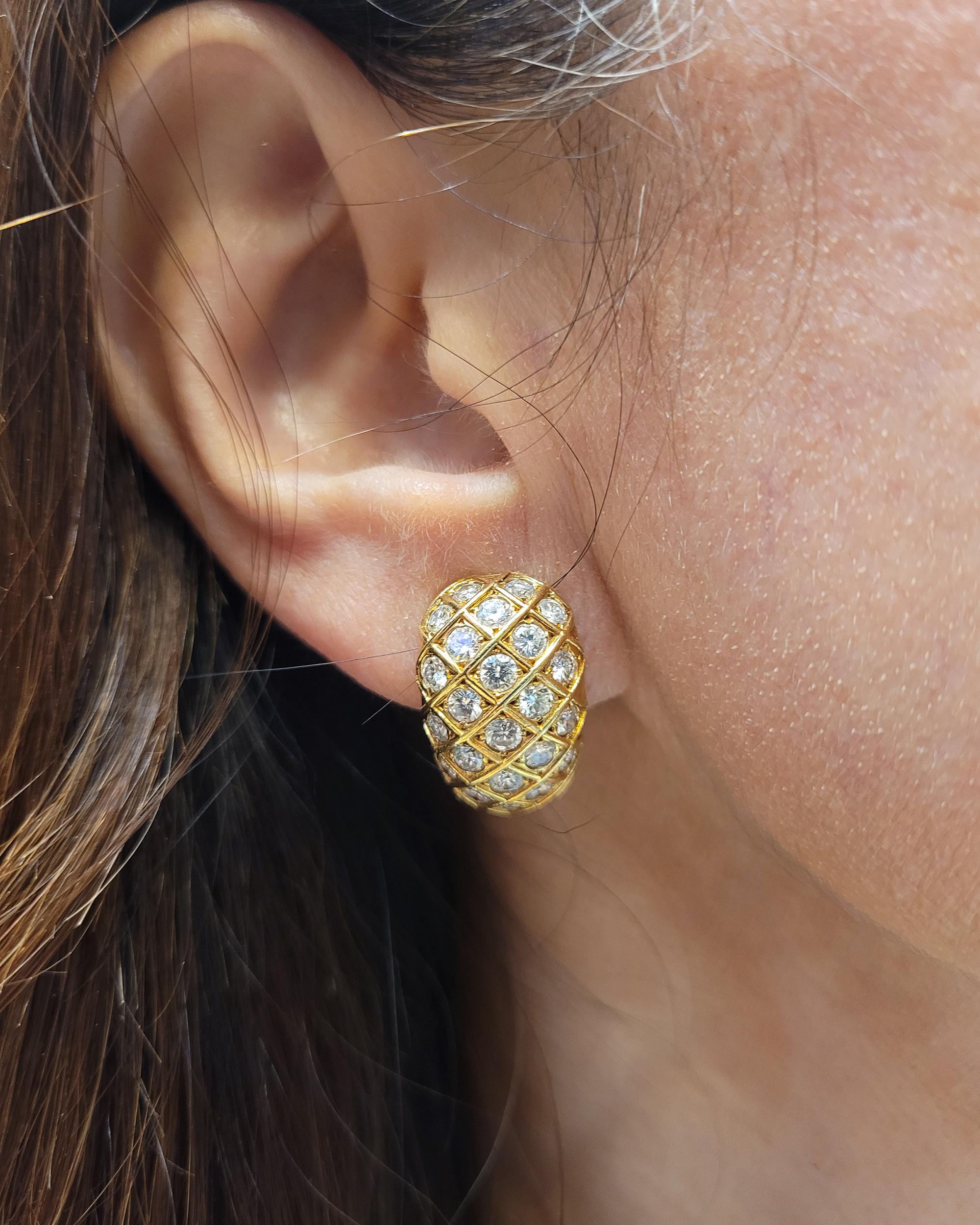 This extraordinary pair of Van Cleef & Arpels Diamond 'Huggie' Earrings, made in France in the 21th century, circa 2000s, feature dazzling diamonds within a striking geometric and graphic design. Crafted in 18K yellow gold, the symmetrical pair of
