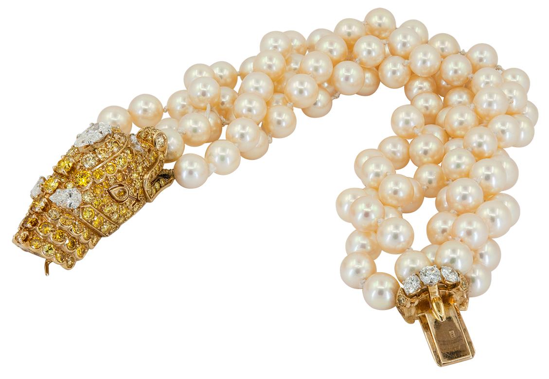 VAN CLEEF & ARPELS Diamond, Multi-Strand Pearl Bracelet

An 18k yellow gold dolphin head bracelet, set with fancy-yellow and white diamonds, and five-row of cultured pearls.Pearl measures approx. 7.0mm
The bracelet measures approx.  8″- 8.50″ in