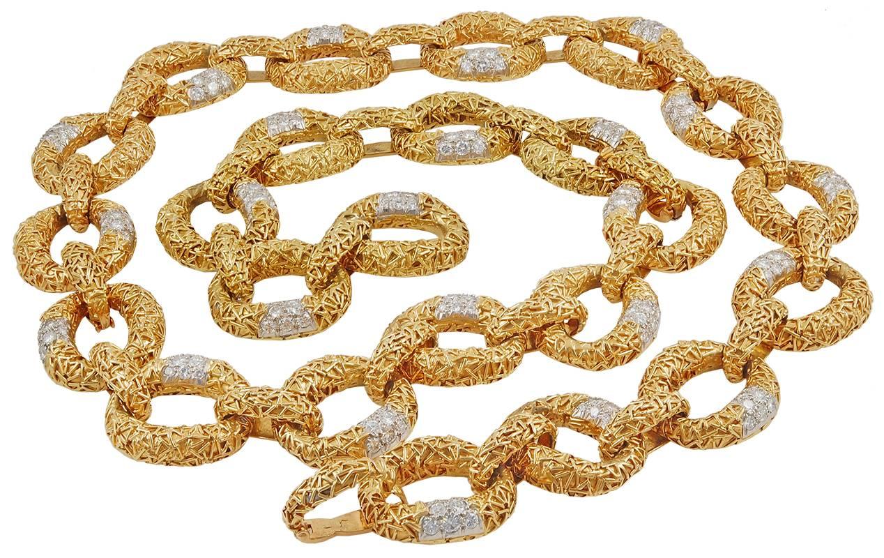 An exquisite pendant composed of textured gold, accented by luminous round diamonds, suspended from a similarly-set necklace, total gross weight approximately 202 dwt., length 28½ inches, with four removable segments for a variety of wear each
