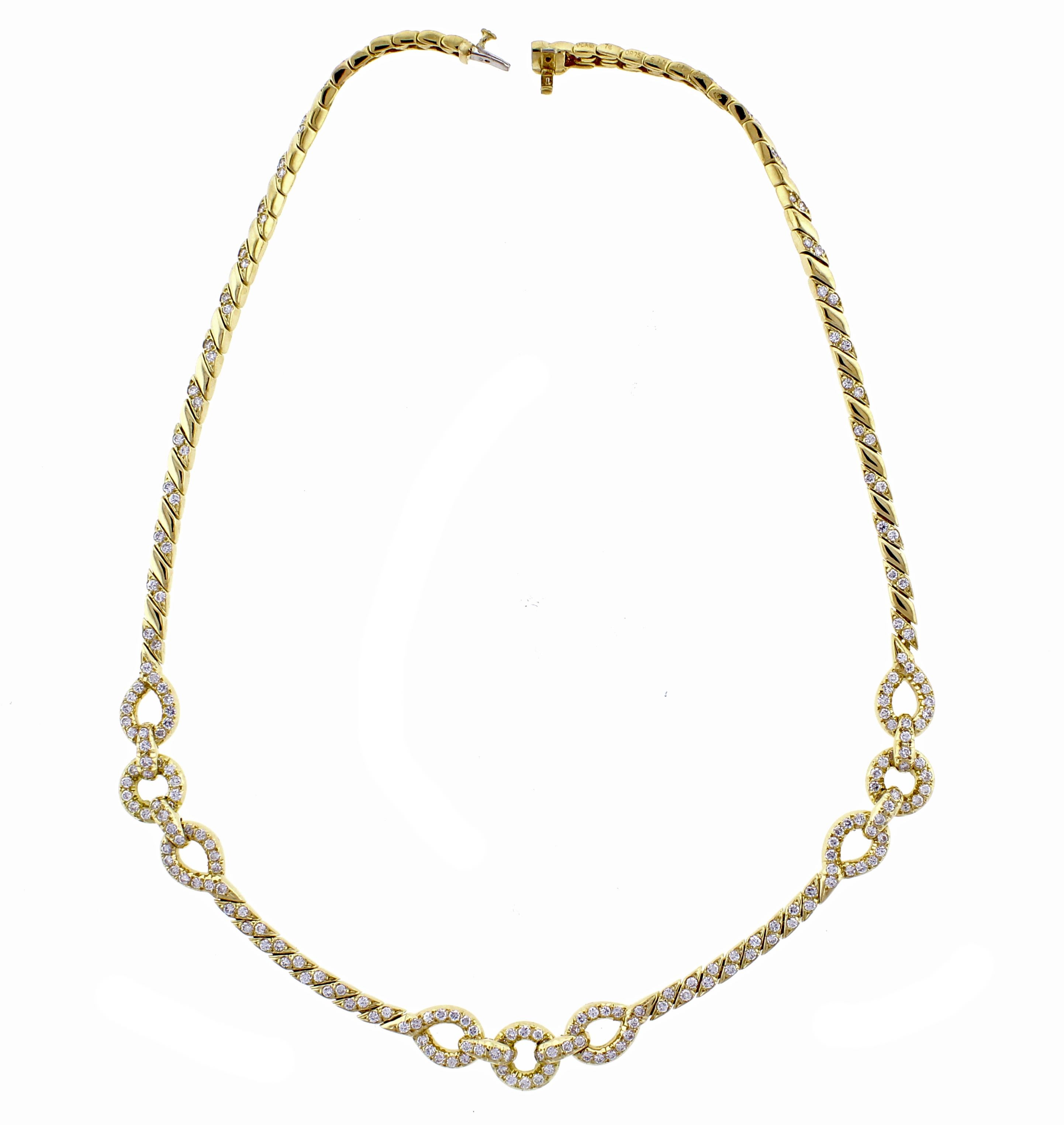 From  Van Cleef & Arpels, a diamond necklace. The 18 karat gold necklace features three sections each comprised of loops and circles among a braided diamond link. The braided link measures 4mm across, while the circles are 10mm The 214 brilliant
