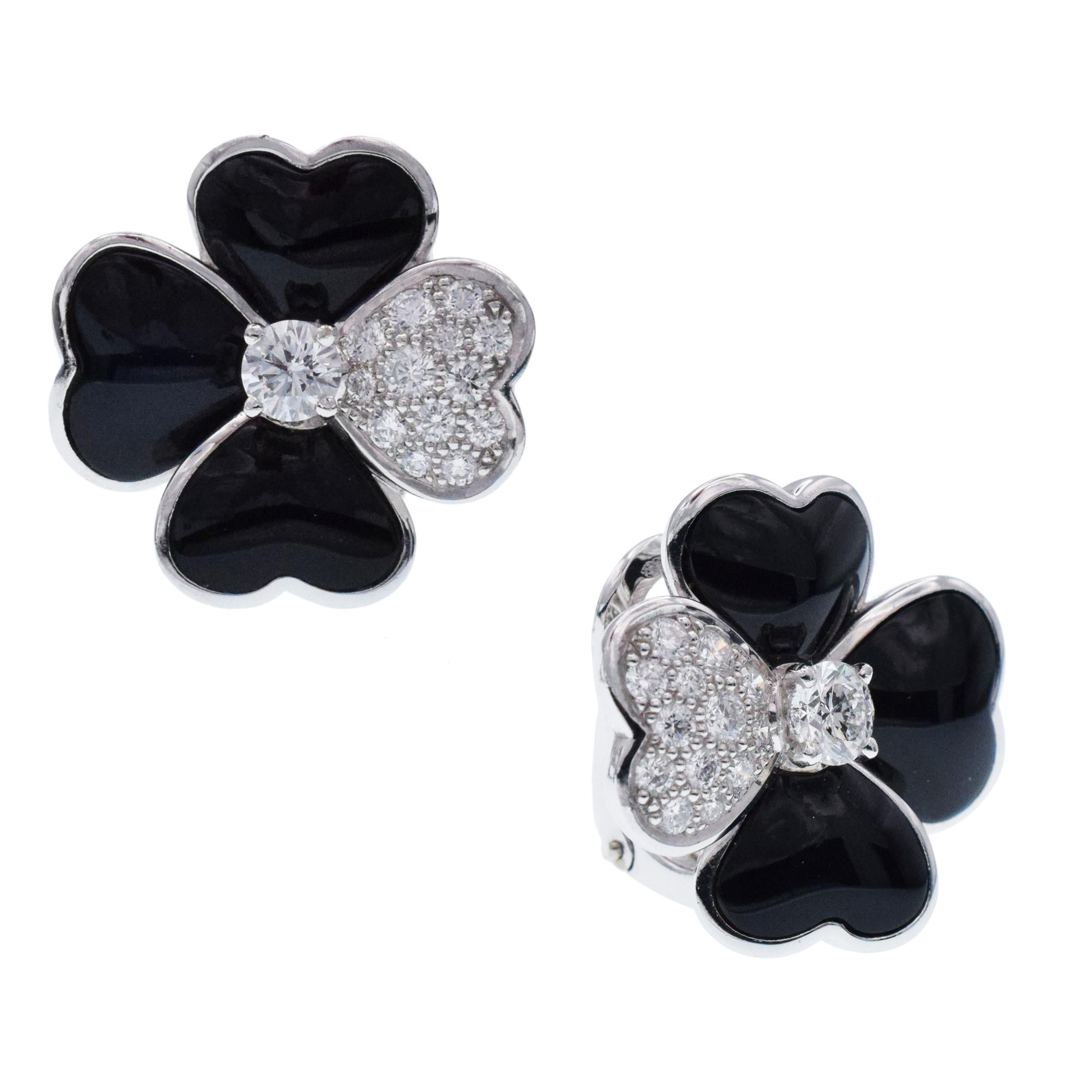 Van Cleef & Arpels Diamond, Onyx, and White Gold 'Cosmos' Clip Earrings
These earrings have flowers set with black onyx petals and round brilliant cut diamonds weighing approximately 1.21 carats total all in 18 karat white gold. 
Signed VCA, Au750,