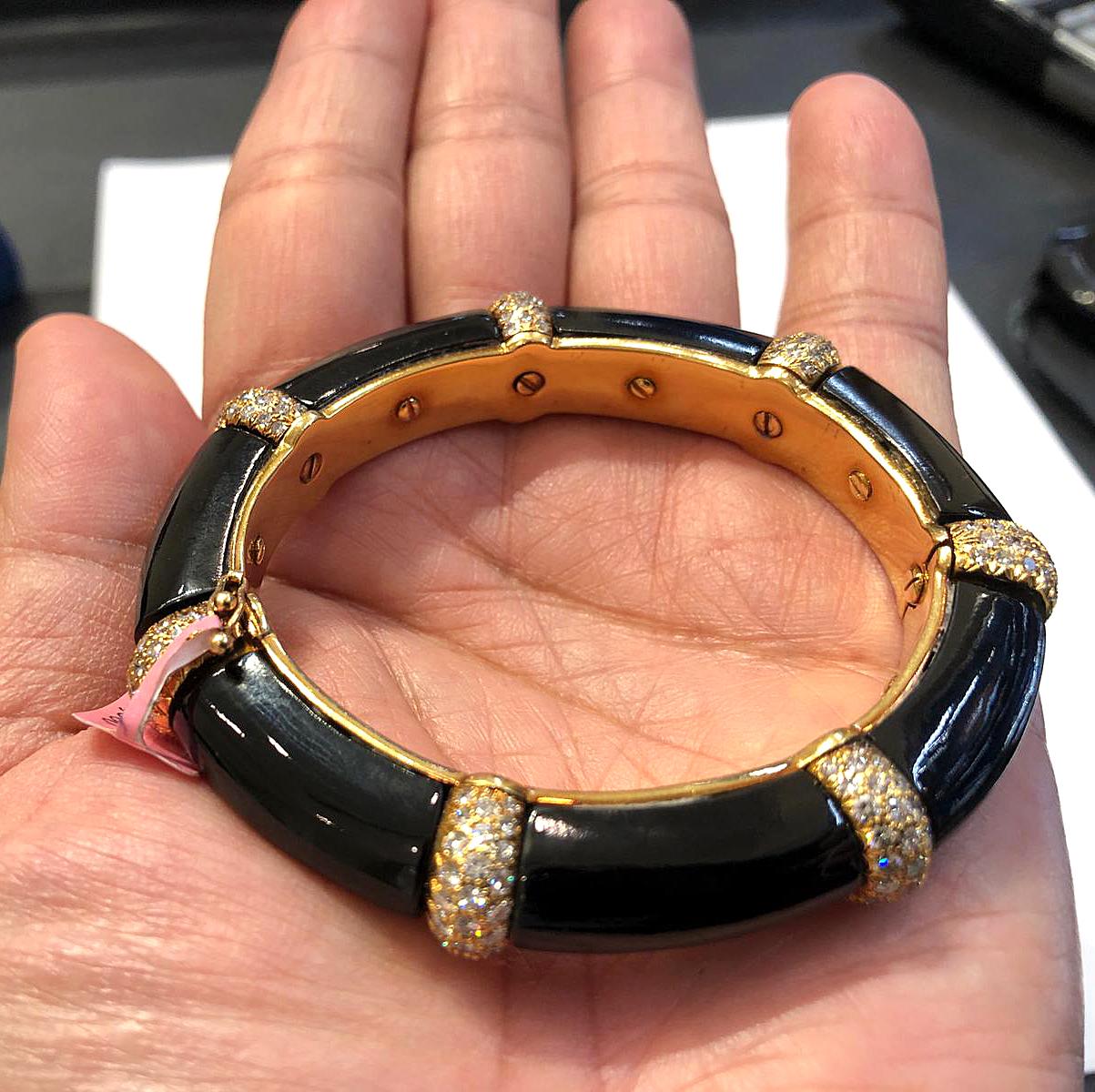 Exceptionally designed as a series of onyx links, joined by 18K gold bands embellished with brilliant circular-cut diamonds. Circumference – approx. 2″ x 2″.  Signed Van Cleef & Arpels.
 