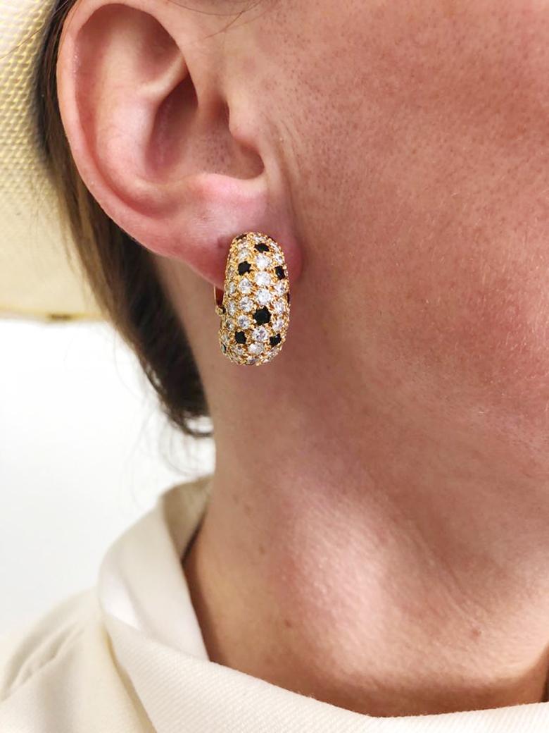 VAN CLEEF & ARPELS Pelouse Diamond Onyx Bombe Earrings in 18k Yellow Gold.

A bejeweled pair of mini on-the-ear clips by Van Cleef & Arpels exhibiting a design emblematic of the Maison: the domed voluminous forms of 'Pelouse' (in some books this