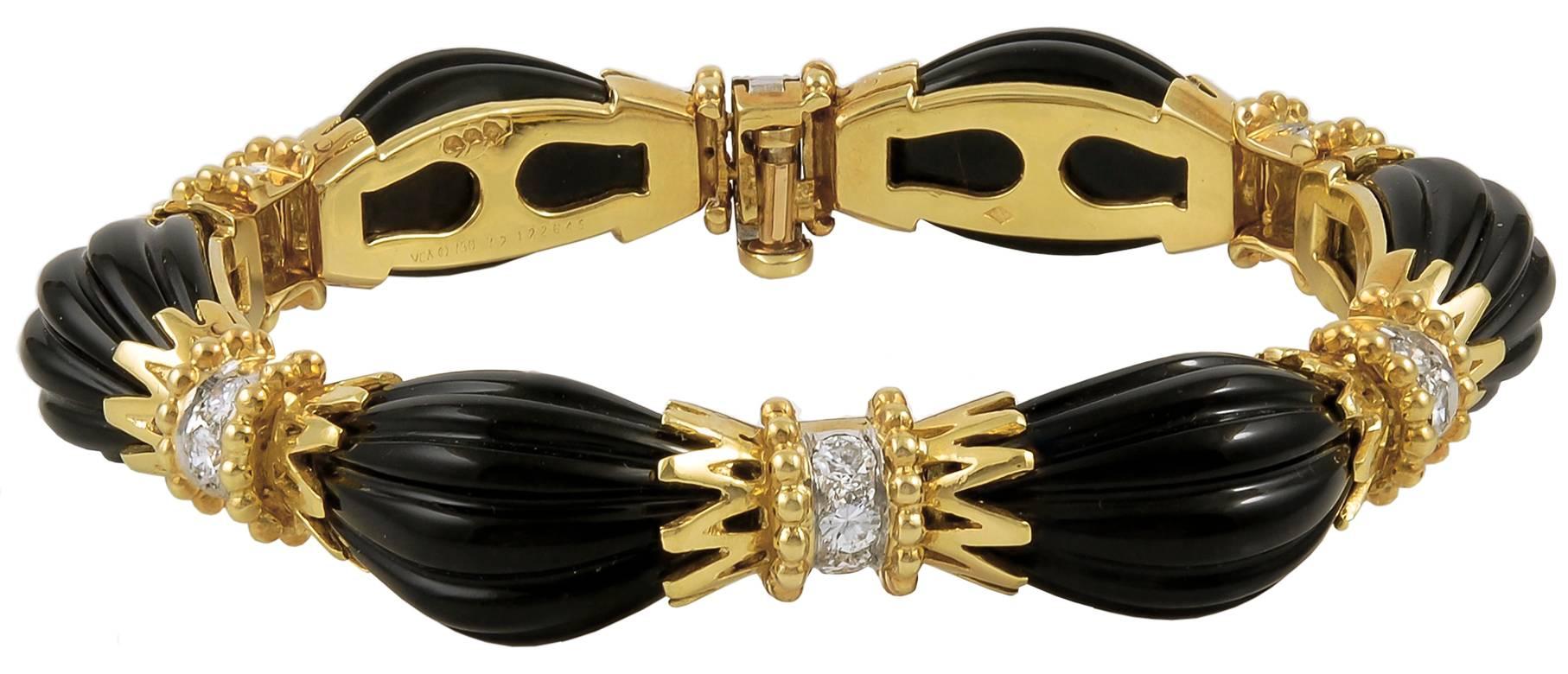 Van Cleef & Arpels Carved Onyx Diamond Convertible Suite in 18k Yellow Gold.

This necklace, earring, and bracelet suite is features carved onyx accented with diamond clusters mounted in yellow gold. The necklace is convertible and separates into an