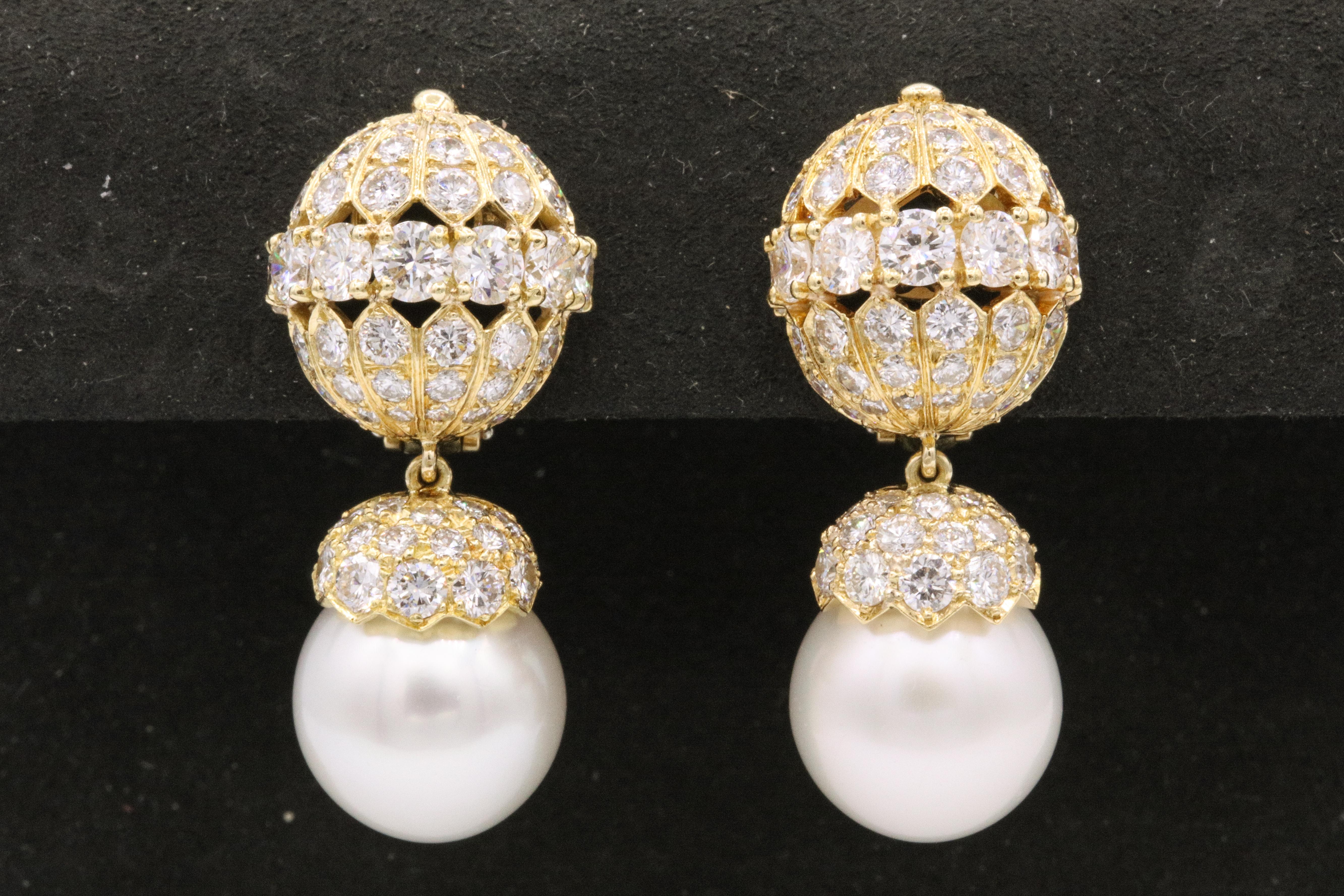 Van Cleef & Arpels cultured pearl and diamond earclips. The two cultured pearls measure approximately 12.5 mm, capped by round brilliants.
Signed: Van Cleef & Arpels, numbered 2402 S.O.; Circa 1965

Comes with Paperwork and pouch. 
Property of