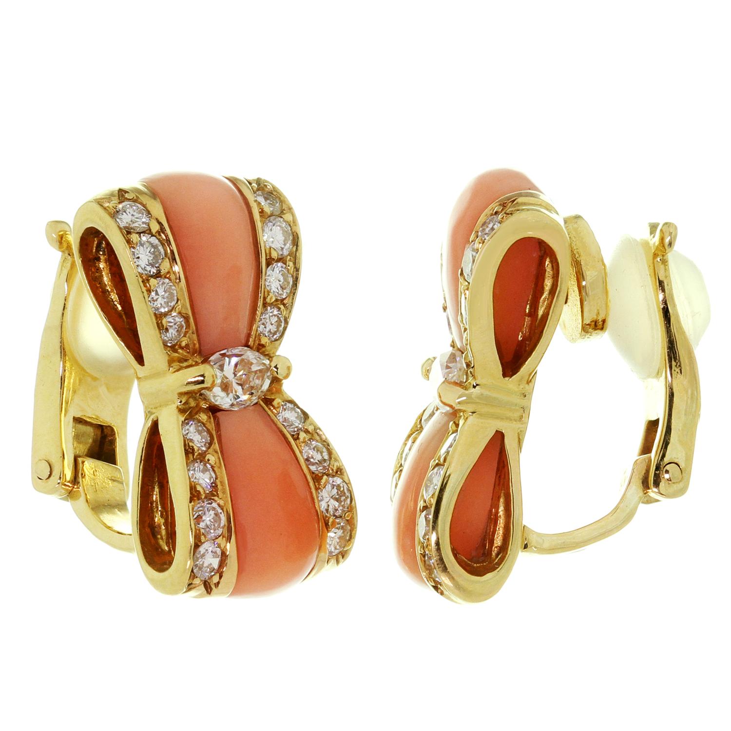 These exqusite vintage clip-on Van Cleef & Arpels earrings are crafted in 18k yellow gold and feature a bow-shaped design set with pink coral and brilliant-cut round E-F VVS1-VVS2 diamonds weighing an estimated 1.16 carats. Made in France circa
