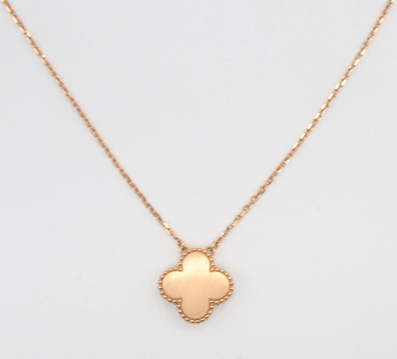 This is an authentic VAN CLEEF & ARPELS 18K Rose Gold Pink Porcelain Diamond Vintage Alhambra Pendant Necklace. This stunning necklace chain is crafted of 18 karat rose gold. The pendant is in the shape of a small clover set with pink porcelain and