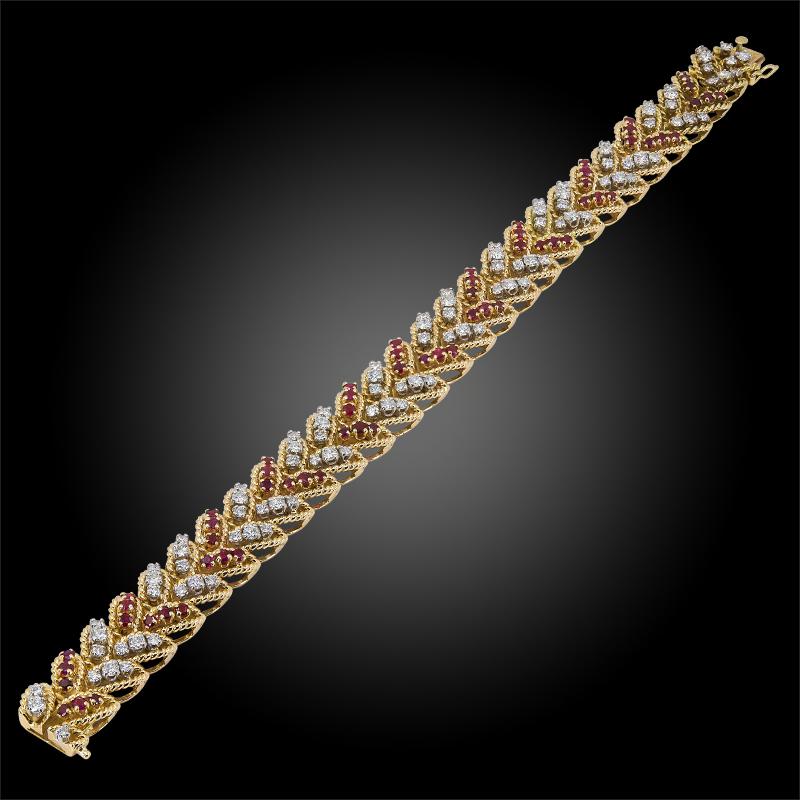 Van Cleef & Arpels Diamond Ruby Leaf Bracelet in 18k Yellow Gold.
Opposing laurel leaves stacked into a pattern of round brilliant rubies and diamonds are the focal point of this Van Cleef & Arpels bracelet.

Measures approx 7.75″ in length, 0.48″
