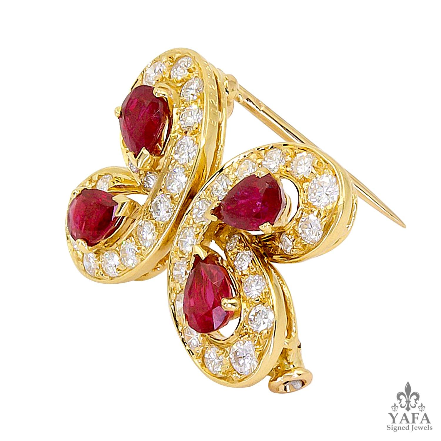 A petite butterfly brooch by Van Cleef & Arpels dating from the 1980s. This abstract pin features a quatrefoil with oval-cut radiant rubies framed with white round brilliant diamonds, all mounted in yellow gold.

Measures approx. 0.50