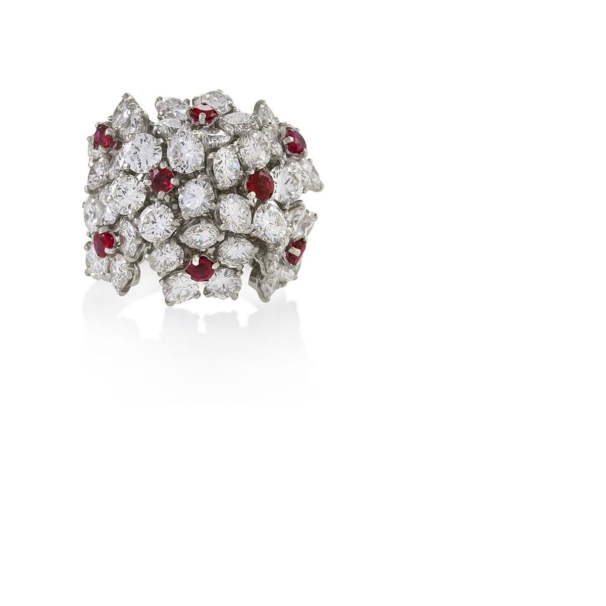 An American platinum ring with diamonds and rubies by Van Cleef & Arpels. The ring has 40 round brilliant-cut diamonds with an approximate total weight of 6.00 carats,with 8 round rubies with the approximate total weight of .80 carat as an accent of