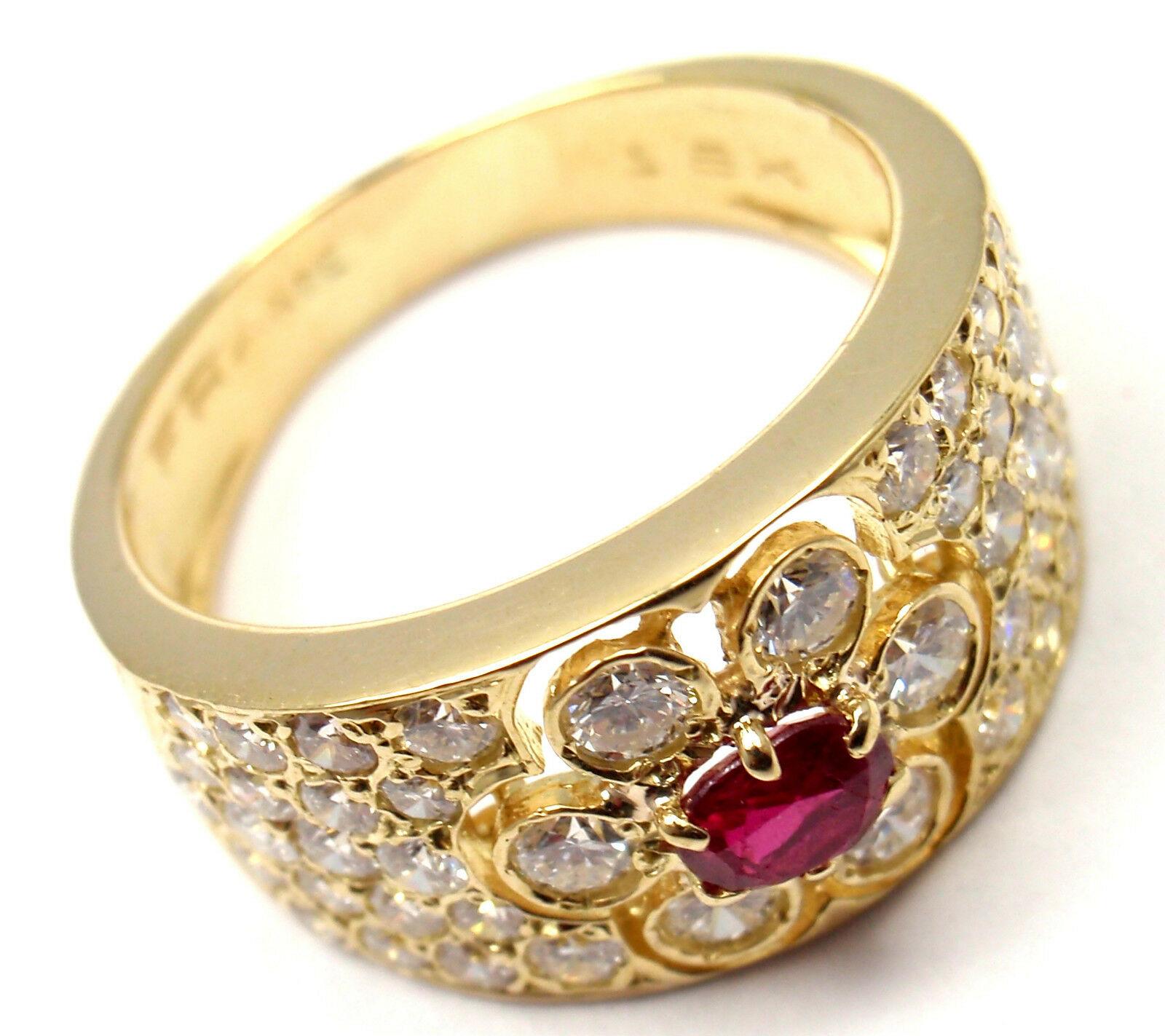 18k Yellow Gold Diamond Ruby Flower Band Ring by Van Cleef & Arpels. 
With 46 round brilliant cut diamond VVS1 clarity, E color total weight approx. 1.25ct
1 round ruby
Details:
Weight: 5.9 grams
Size: 6
Width: 10mm
Stamped Hallmarks: VCA France 18k