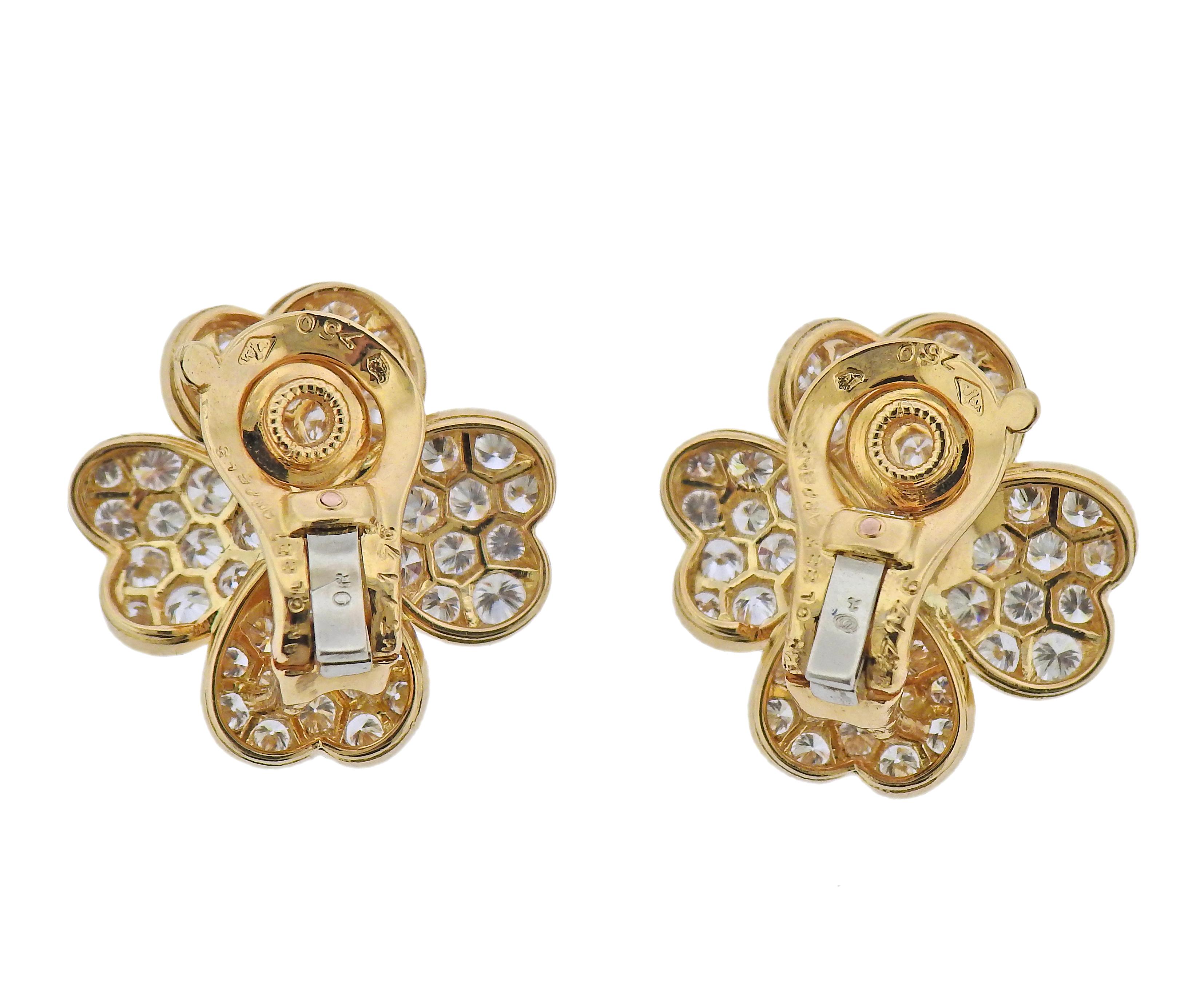 Pair of 18k gold flower earrings by Van Cleef & Arpels, with approx. 3.60ctw in F/VVS diamonds and center rubies. Earrings are 21mm x 20mm. Marked: 750, Van Cleef & Arpels, M3176, or 750. Weight - 9 grams. 