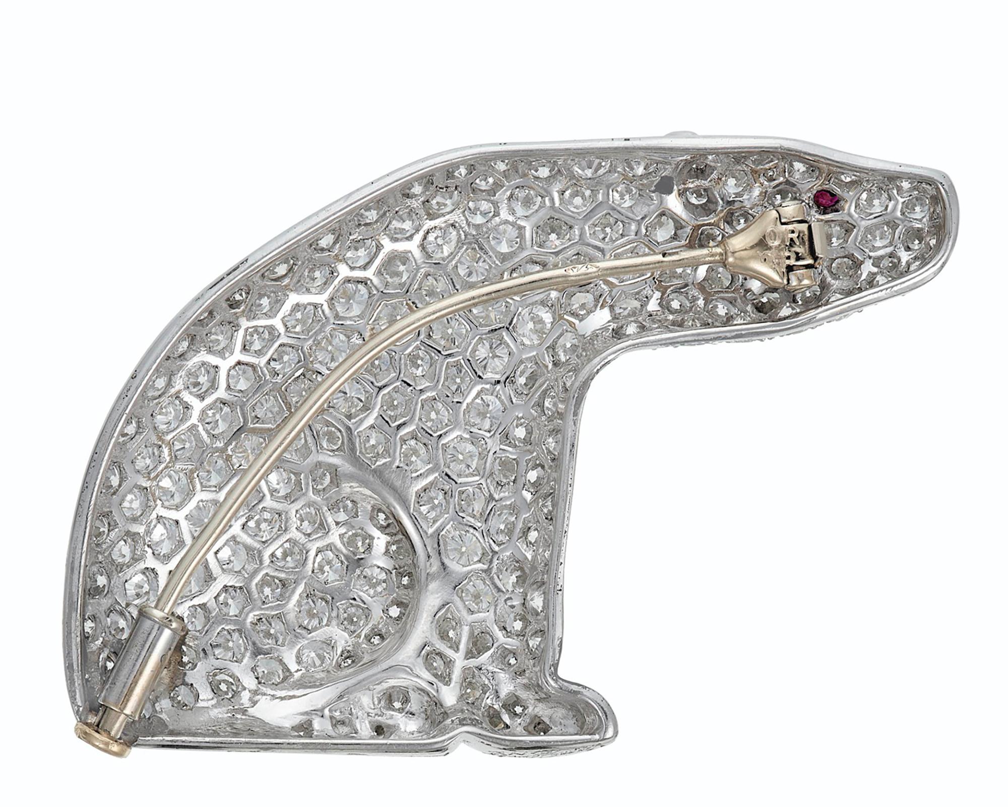 A gorgeous brooch designed as a polar bear and embellished with diamonds and ruby, circa 1970. 
Mounted in platinum.
155 circular-cut diamonds totaling to 3.00-3.50 carats of F-G color, VVS-VS clarity.
Ruby bright and lively, single pinstem.
Signed