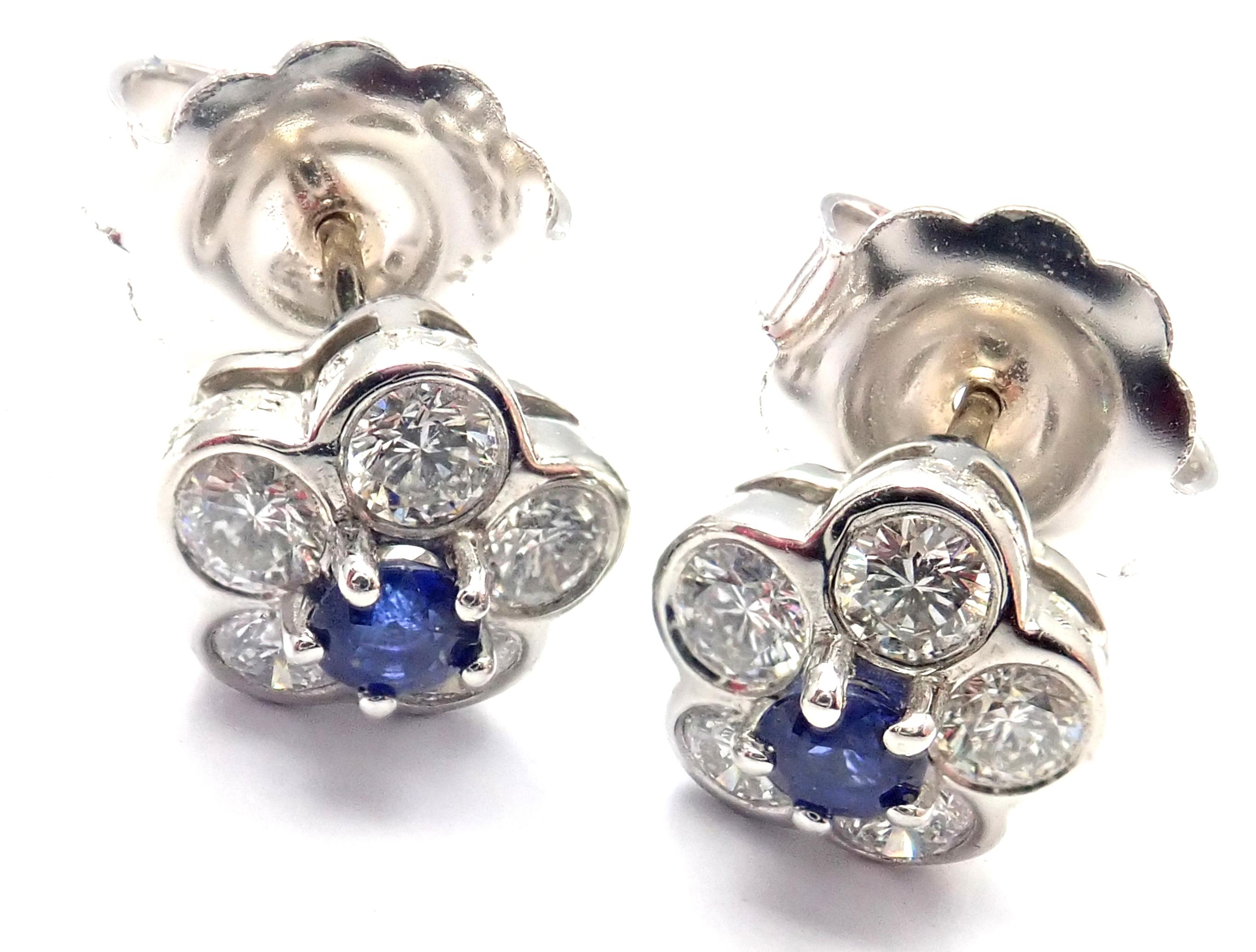 Platinum Diamond Sapphire Flower Earrings by Van Cleef & Arpels. 
With10 round brilliant cut diamond VVS1 clarity, E color total weight approx. .50ct
2 round sapphires total weight approx. .20ct
***These earrings are for pierced ears.***
Details: