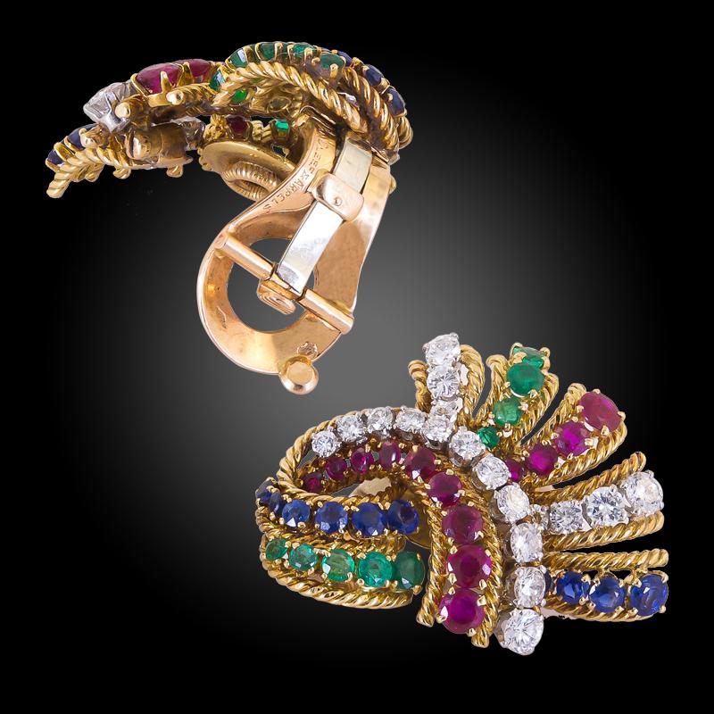 VAN CLEEF & ARPELS Diamond Sapphire Ruby Emerald Earrings in 18k Yellow Gold.

An opulent pair of fan-shaped on-the-ear clips with stunning color combinations - featuring rubies, sapphires, emeralds, and diamonds to complete the fruitful burst of