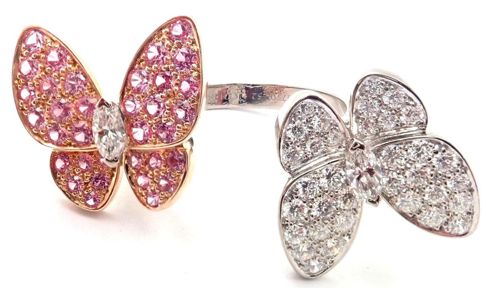 18k White Gold Diamond And Pink Sapphire Two Butterfly Between the Finger Ring 
by Van Cleef & Arpels.
With 36 round brilliant cut diamond VVS1 clarity, E color total weight .99ct
34 round pink sapphires total weight .88ct
This ring comes with Van