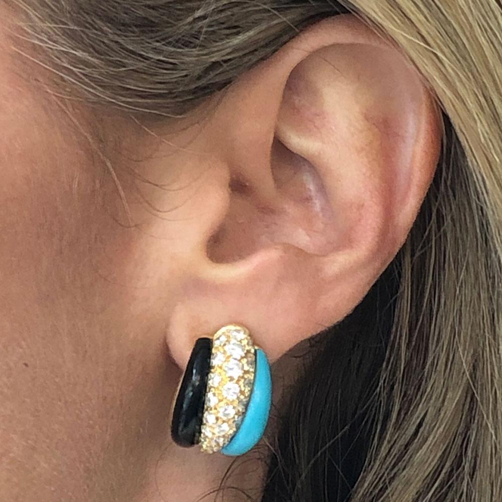 Turquoise, diamond, and onyx estate earrings by Van Cleef & Arpels. These rare estate earrings circa 1980's feature 2.19 carat total weight of white round brilliant cut diamonds. The diamonds are graded DEF color and VVS clarity. The clip earrings