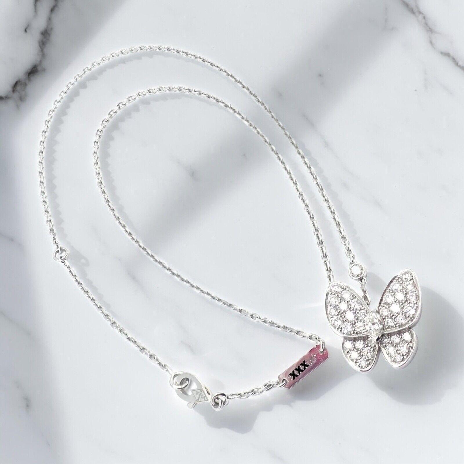 18k White Gold Diamond Two Butterfly Papillon Pendant Necklace by Van Cleef & Arpels. 
The Van Cleef & Arpels Butterfly Pendant Necklace, made from 18k white gold, features a delicate butterfly adorned with sparkling diamonds.
This elegant piece