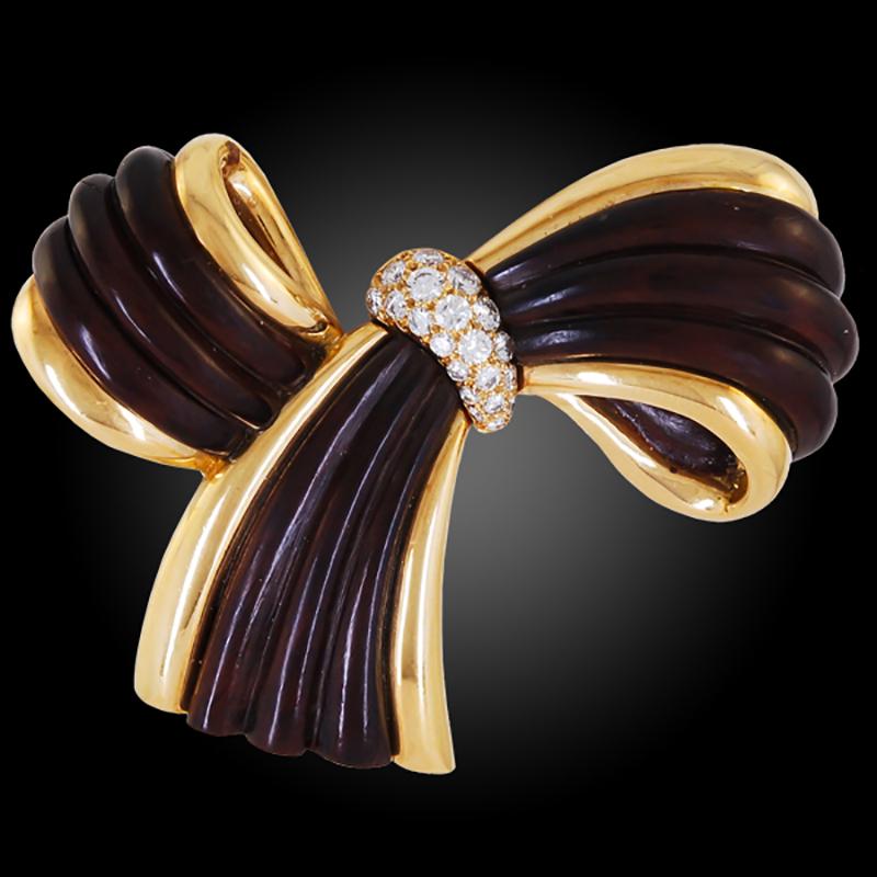 Van Cleef & Arpels Diamond Wood Bow Brooch Ear Clips Suite in 18k Yellow Gold.

This flowing Van Cleef & Arpels bow brooch is exemplary to designs of the second half of the 20th Century for the Maison. The bow motif has been a classic since the