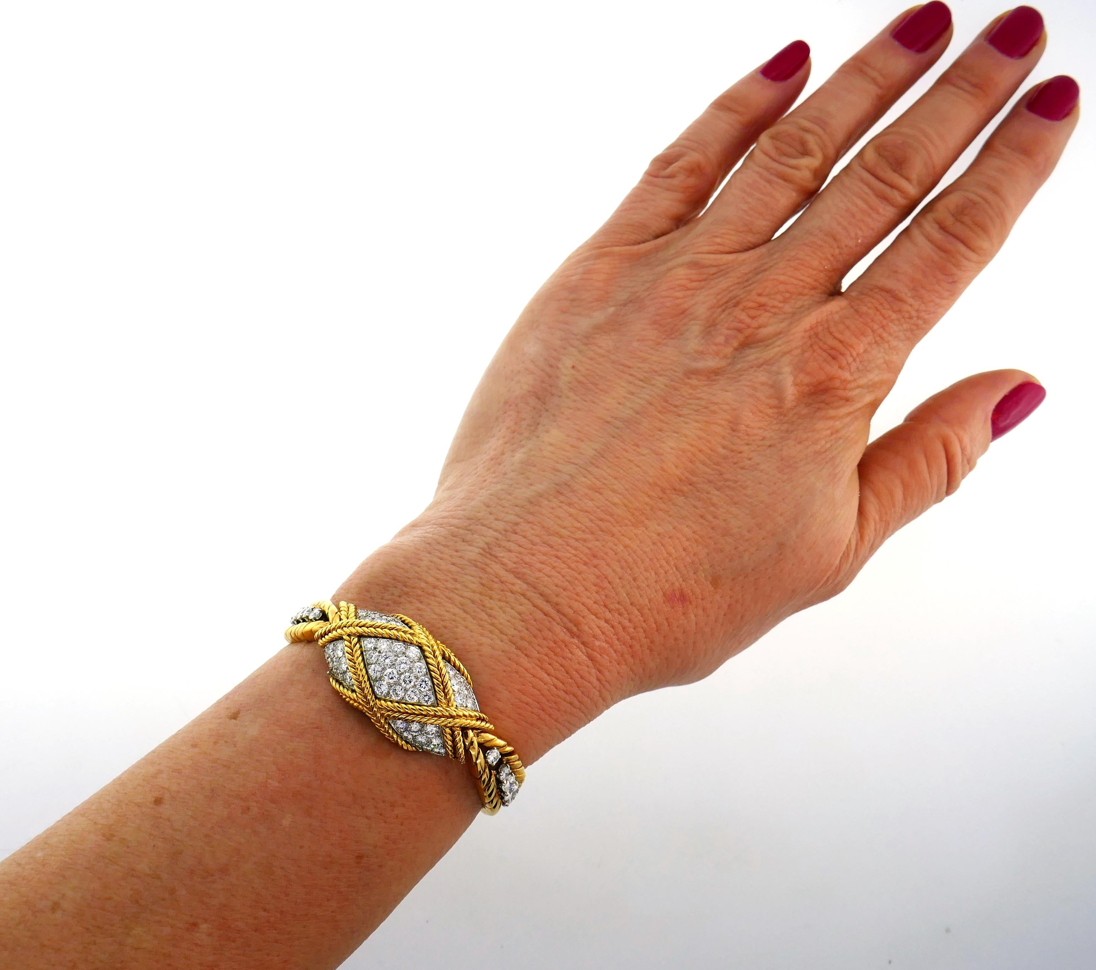 Feminine and elegant lady's watch/bracelet created by Van Cleef & Arpels in the 1950's. 
The watch is made of 18 karat (tested) yellow gold and encrusted with round brilliant cut diamonds (F-G color, VS1 clarity, total weight approximately 2.82