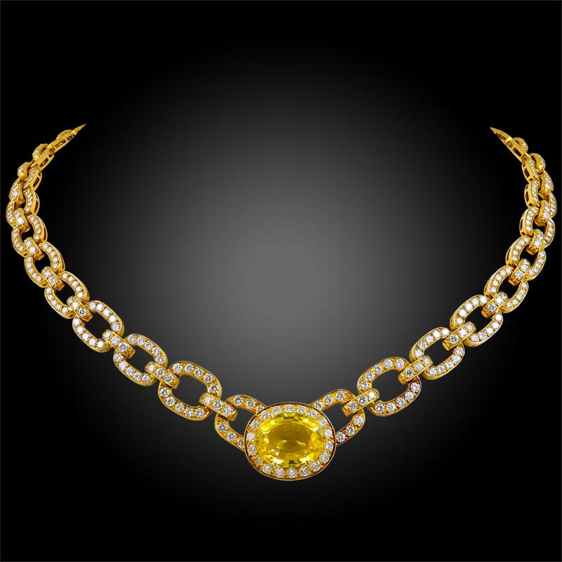 An impeccable trio by Van Cleef & Arpels, this 1980's set is comprised of a necklace, earrings, and ring, all of which are finely set with an opulence of brilliant-cut diamonds and radiant oval shaped yellow sapphires, finely mounted in 18k yellow