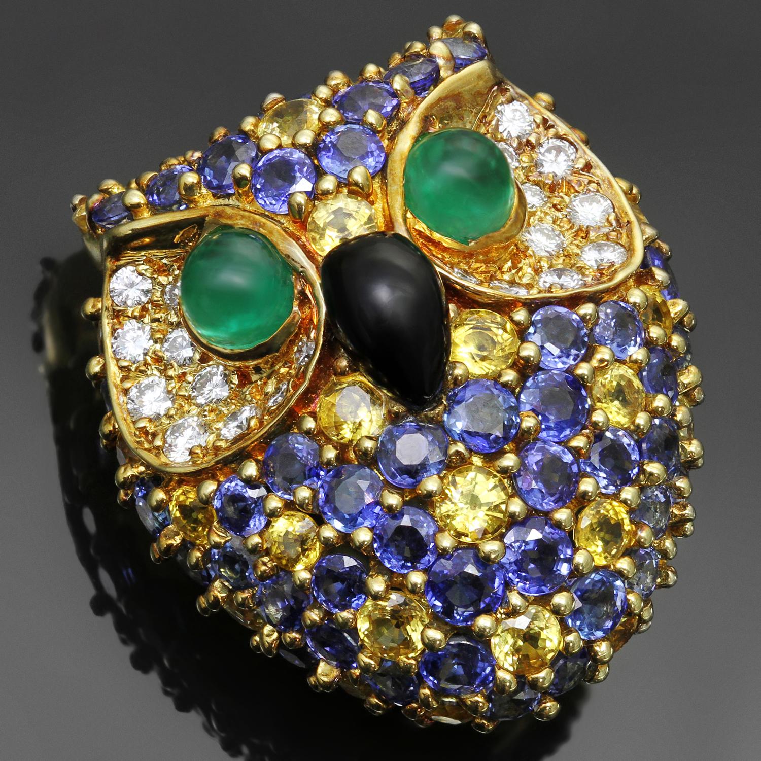 This rare and spectacular Van Cleef & Arpels brooch features a sparkling owl design crafted in 18k yellow gold and set with 20 diamonds of an estimated 0.70 carats, 73 yellow and blue sapphires of an estimated 8.00 carats, completed with 2 cabochon