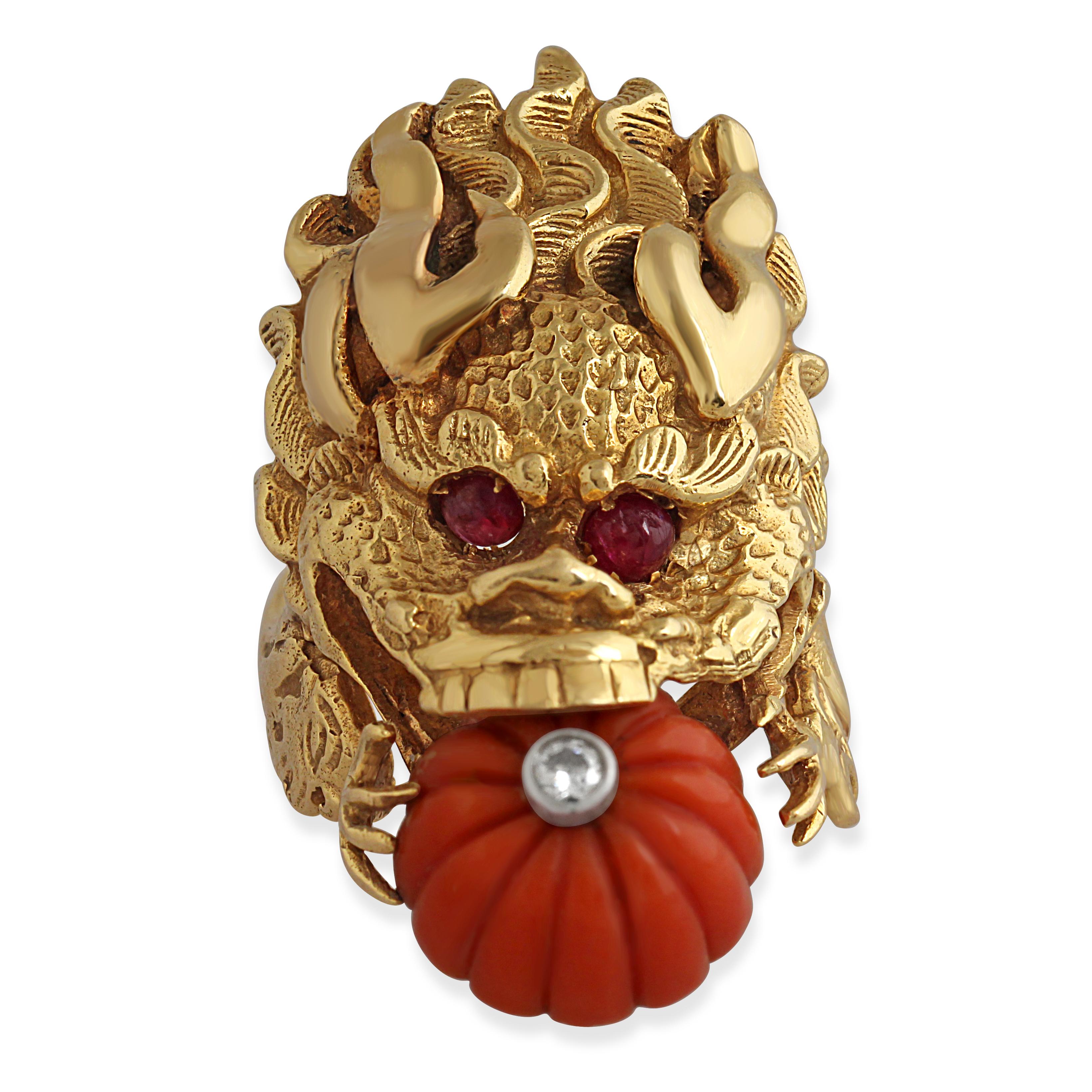 A rare dragon ring by Van Cleef & Arpels. Crafted from 18k yellow gold with a melon-cut coral bead in the mouth of the dragon set with a single diamond at the centre. An exceptional and unique design. Circa 1970s.
