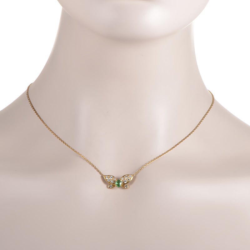 This pendant necklace from Van cleef & Arpels has a whimsical design that sparkles with a rare beauty. The necklace is made of 18K yellow gold and features a petite butterfly-shaped pendant accented with a body made of an ~.30ct emerald and wings