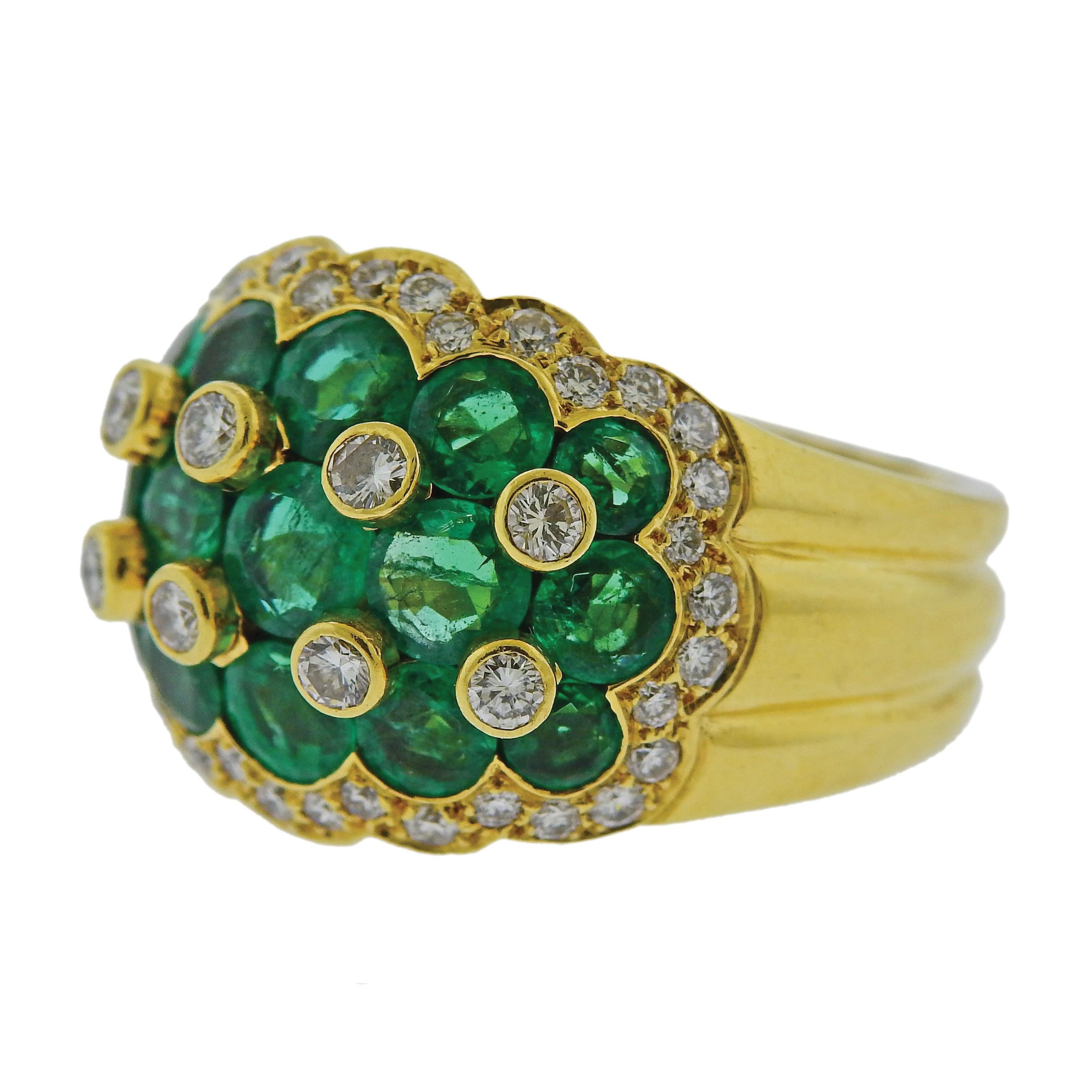 18k yellow gold Van Cleef & Arpels ring, set with emeralds and approx. 0.54ctw in diamonds. The ring is size 6.75, ring top is 17mm wide. Marked Van Cleef & Arpels, 56393, 18k NY. Weighs 14 grams.

SKU#R-01970