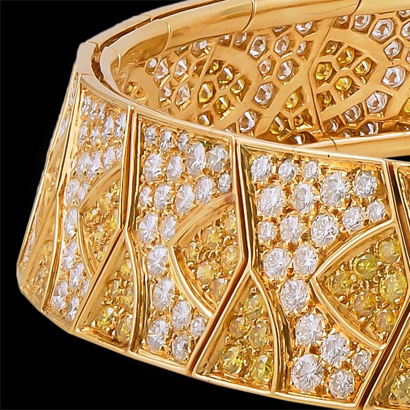 A prestigious piece by Van Cleef & Arpels, this flexible collar necklace is pavé set with an opulence of yellow and white diamonds, weighing approximately 7 and 15 carats respectively, crafted in a repeated geometric panel design, all finely mounted