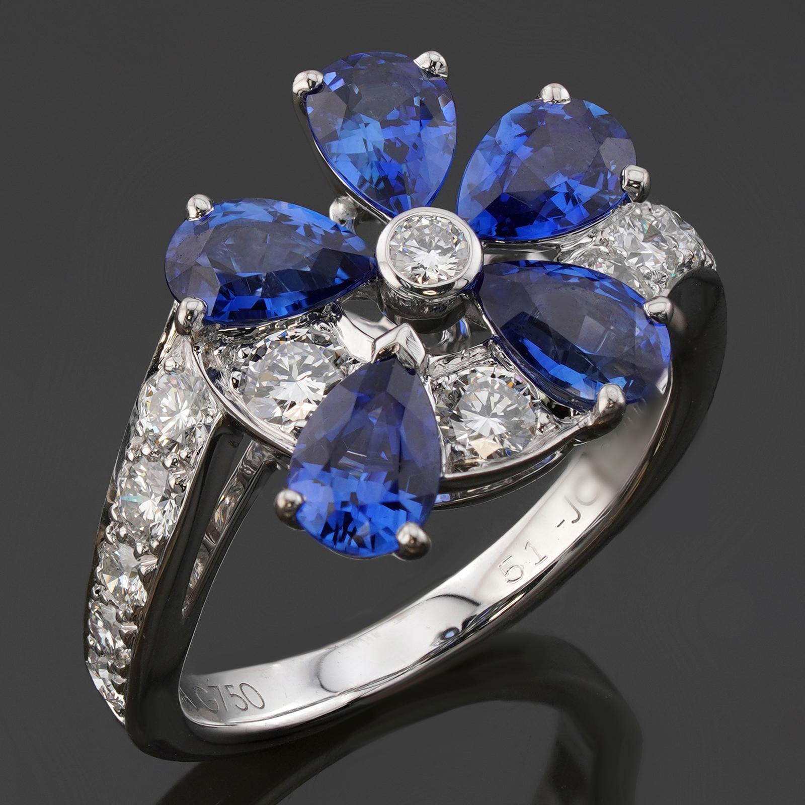 This gorgeous Van Cleef & Aprels ring from the Fil De L'eau collection features a flower design crafted in 18k white gold and set with pear-cut blue sapphires and brilliant-cut round diamonds. Made in France circa 2000s. Measurements: 0.59