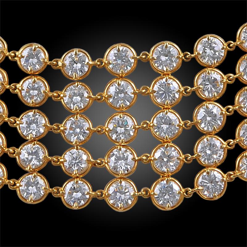 An exceptional and highly flexible necklace by Van Cleef & Arpels that dates back to the 1990s, designed as five rows of graduated round-cut diamonds of exceptional brilliance, exquisitely crafted in 18k yellow gold links.
Signed Van Cleef &