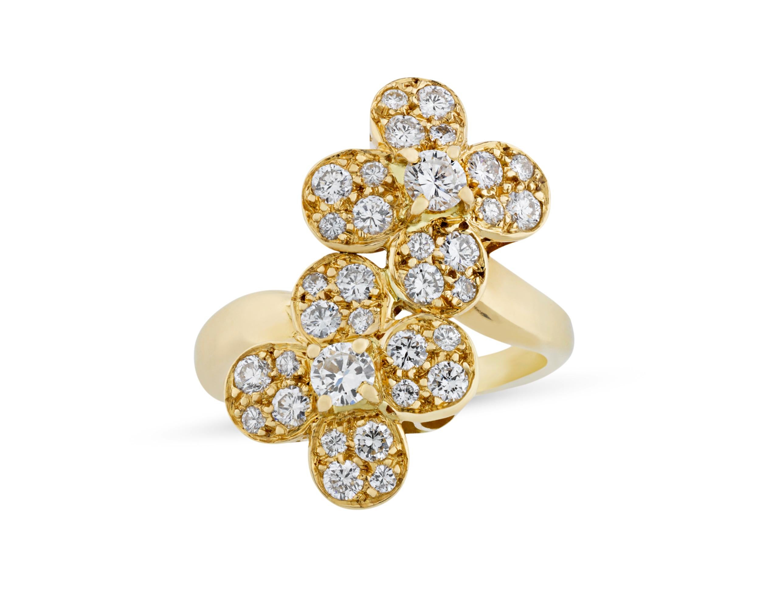 Two interlocking 18K yellow gold flowers encrusted in brilliant-cut round white diamonds bloom in this ring by Van Cleef & Arpels. The diamonds weigh a total of 1.01 carats and display highly desirable D-F color and VVSI-VVS2 clarity. One of the