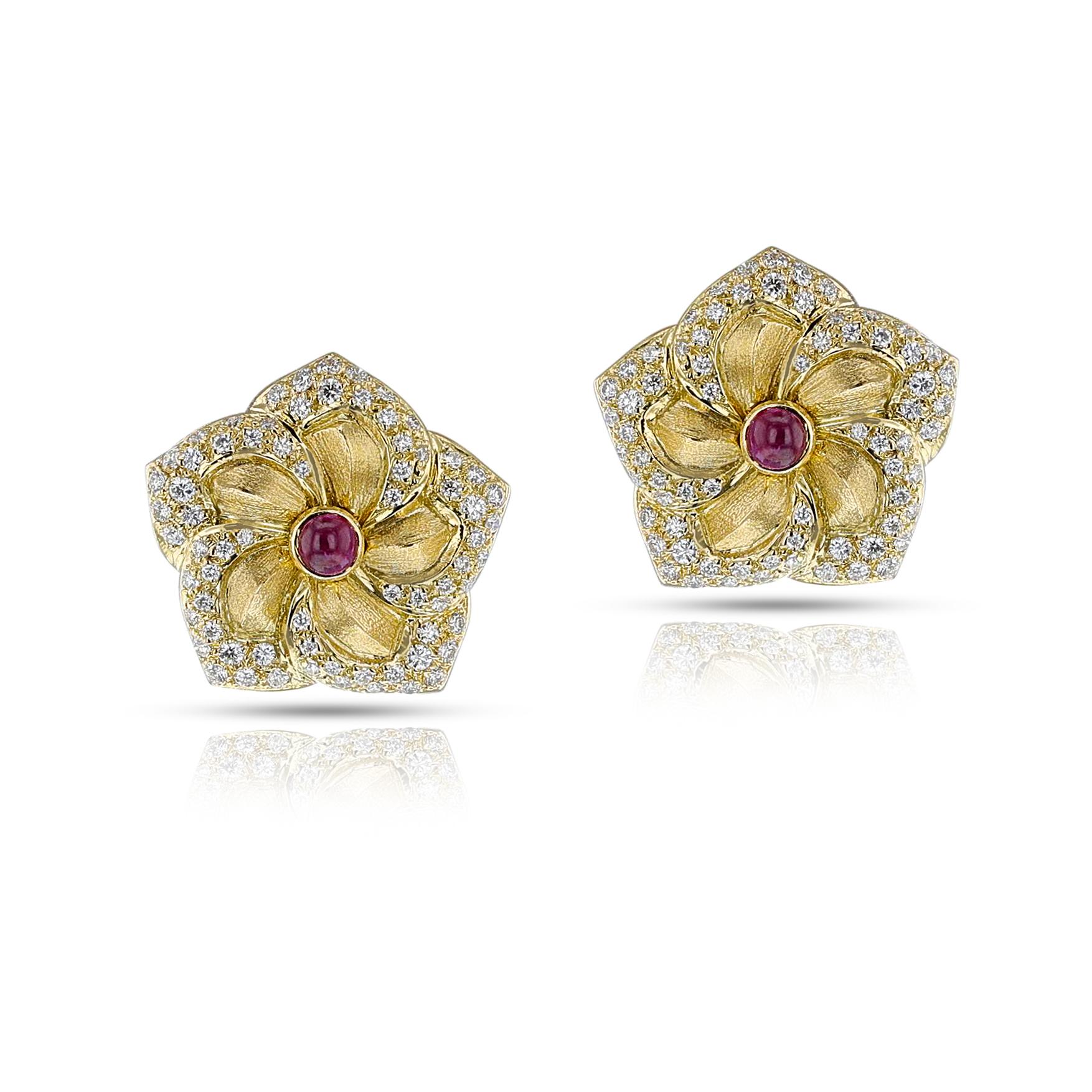 A pair of Van Cleef & Arpels Floral Ruby Cabochon and Diamond Earrings made in 18k. The earring features petals with edges adorned with round diamonds. The center of the earring is set with ruby cabochons. The total weight of the diamonds is appx.