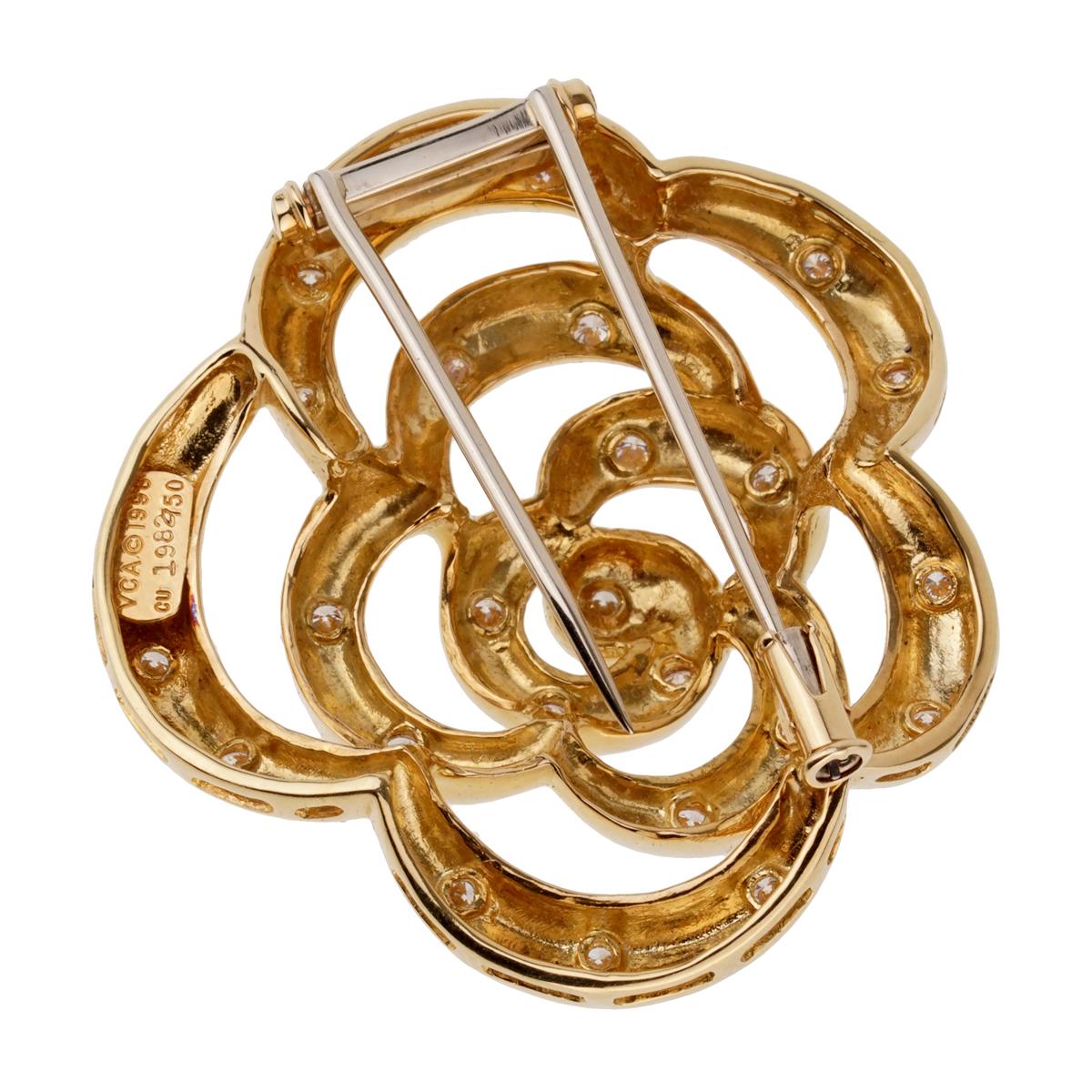A fabulous Van Cleef & Arpels flower brooch circa 1990's adorned with round brilliant cut diamonds set in 18k yellow gold. The brooch measures 1.57