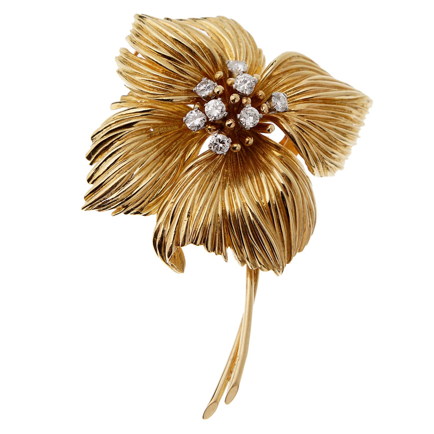 An incredible Van Cleef and Arpels depicting a flower in 18k yellow gold, the brooch is adorned with round brilliant cut diamonds. The brooch can be worn as a pendant as well and measures 2 1/4
