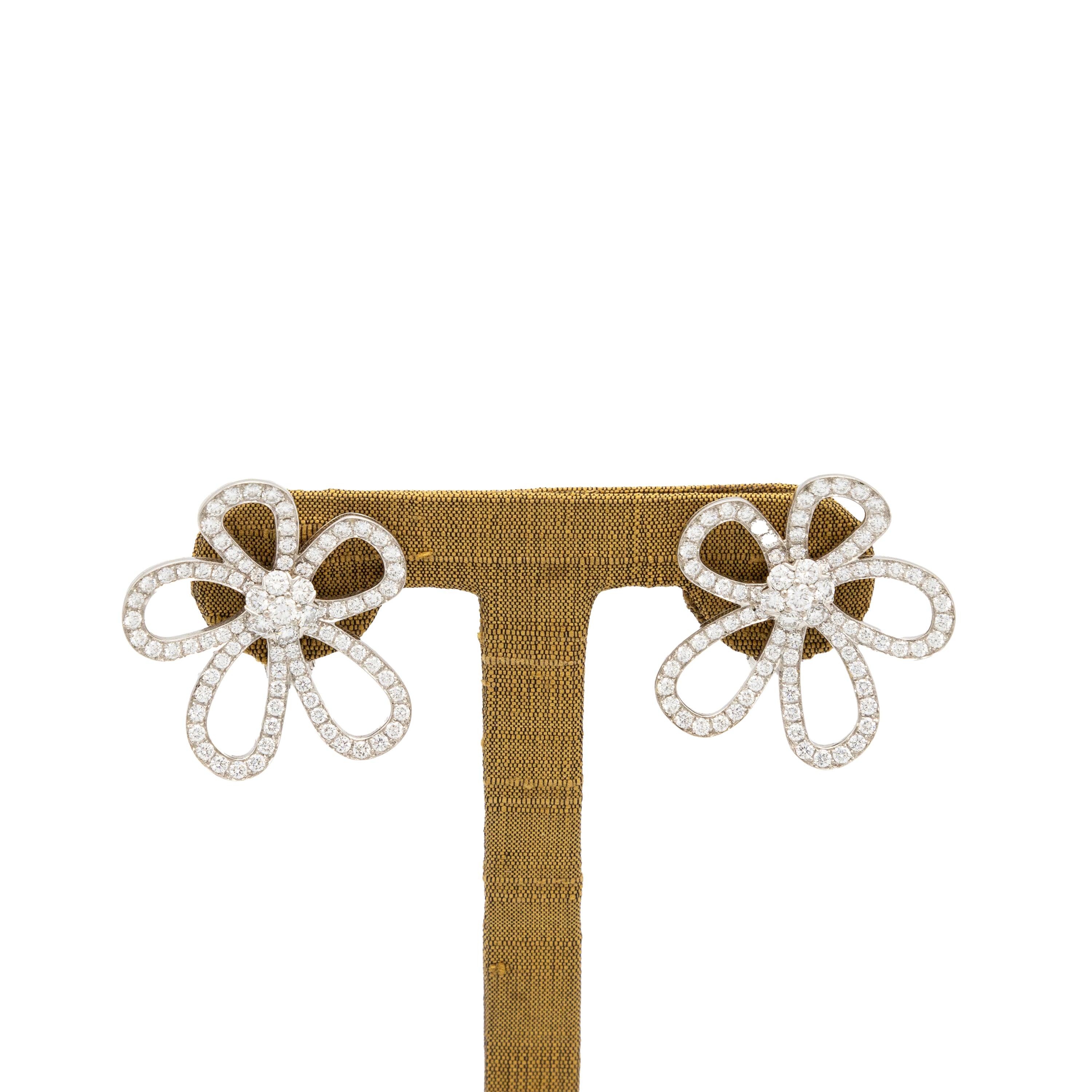 These Van Cleef & Arpels earrings are made of 18K white gold and feature an open flower design entirely embellished with diamonds with a total weight of approximately 2.59 carats.
 The Flowerlace collecaratsion plays on the transparency of lace or